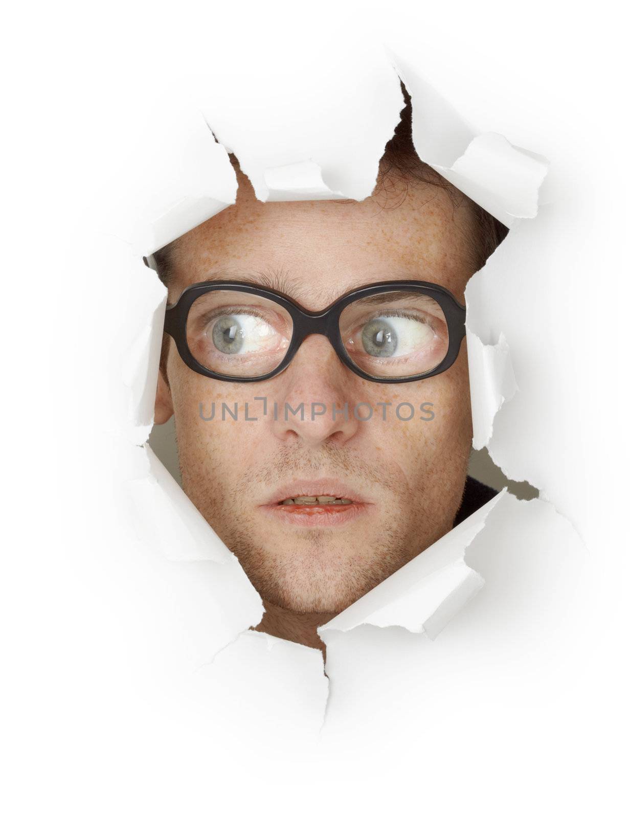 Funny man in an old-fashioned glasses looking out of the hole isolated on white background