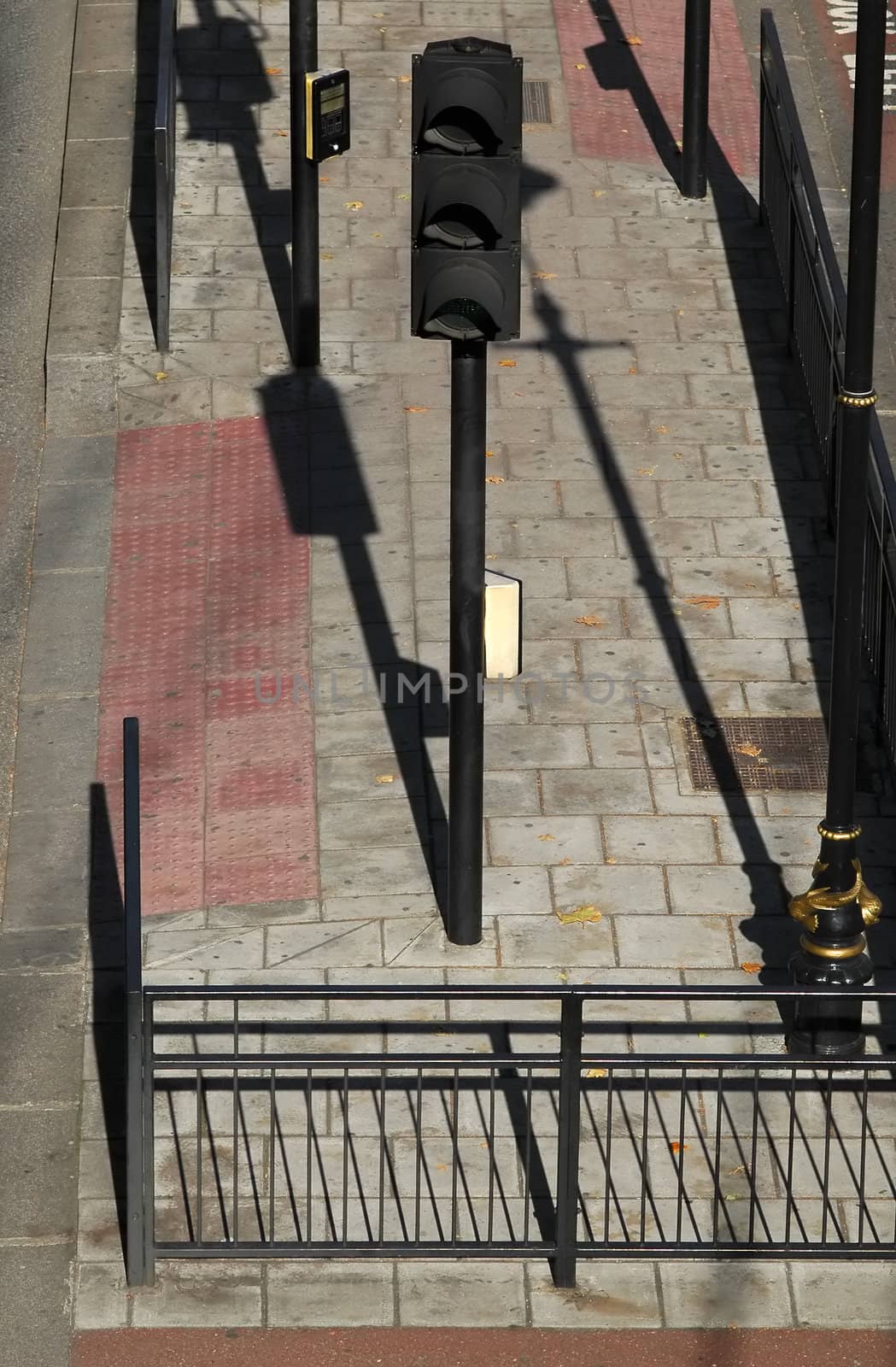 long evening shadows across a traffic light road junction