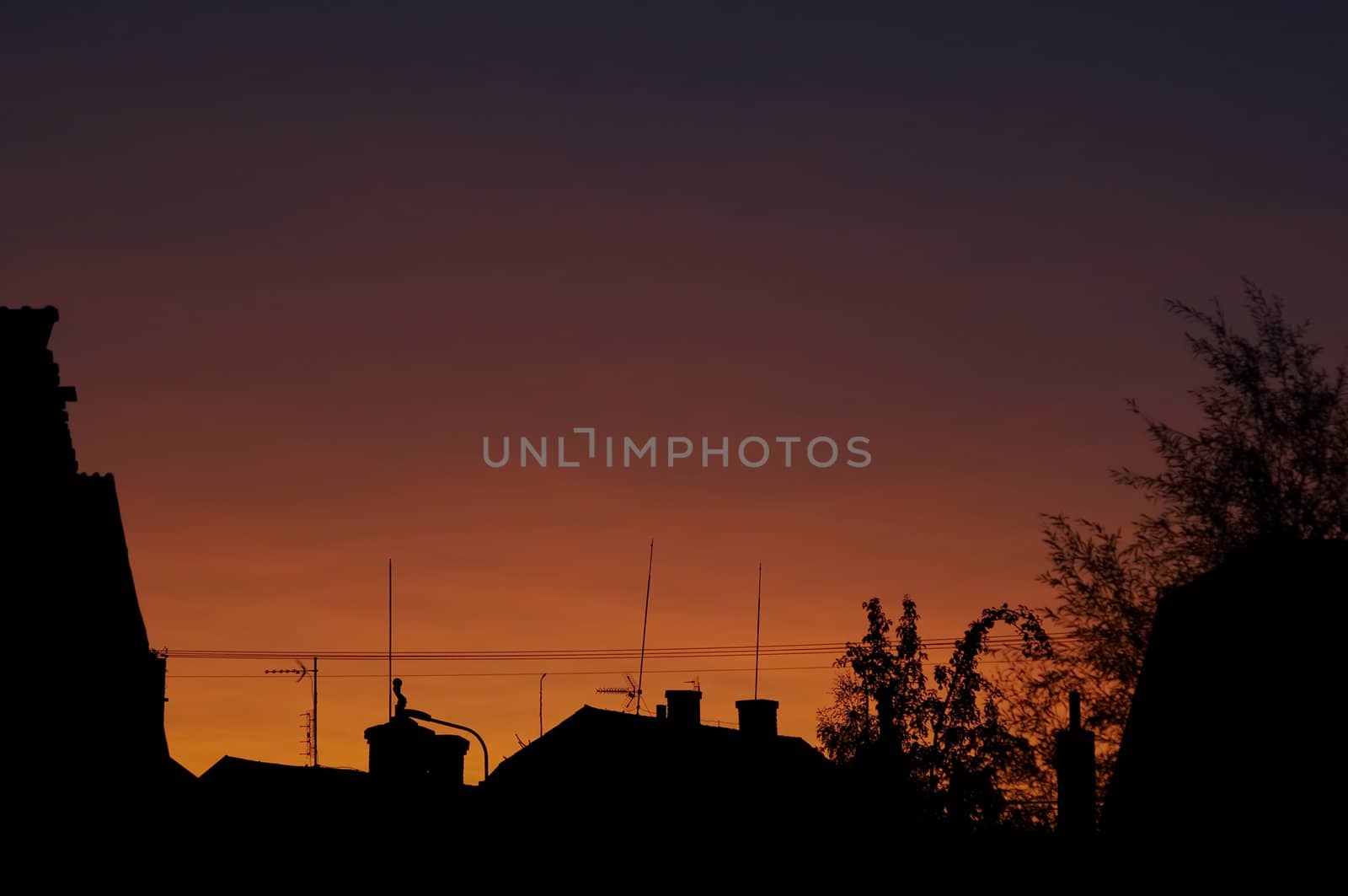 Abstract shot od the sunset, roofs with antennas