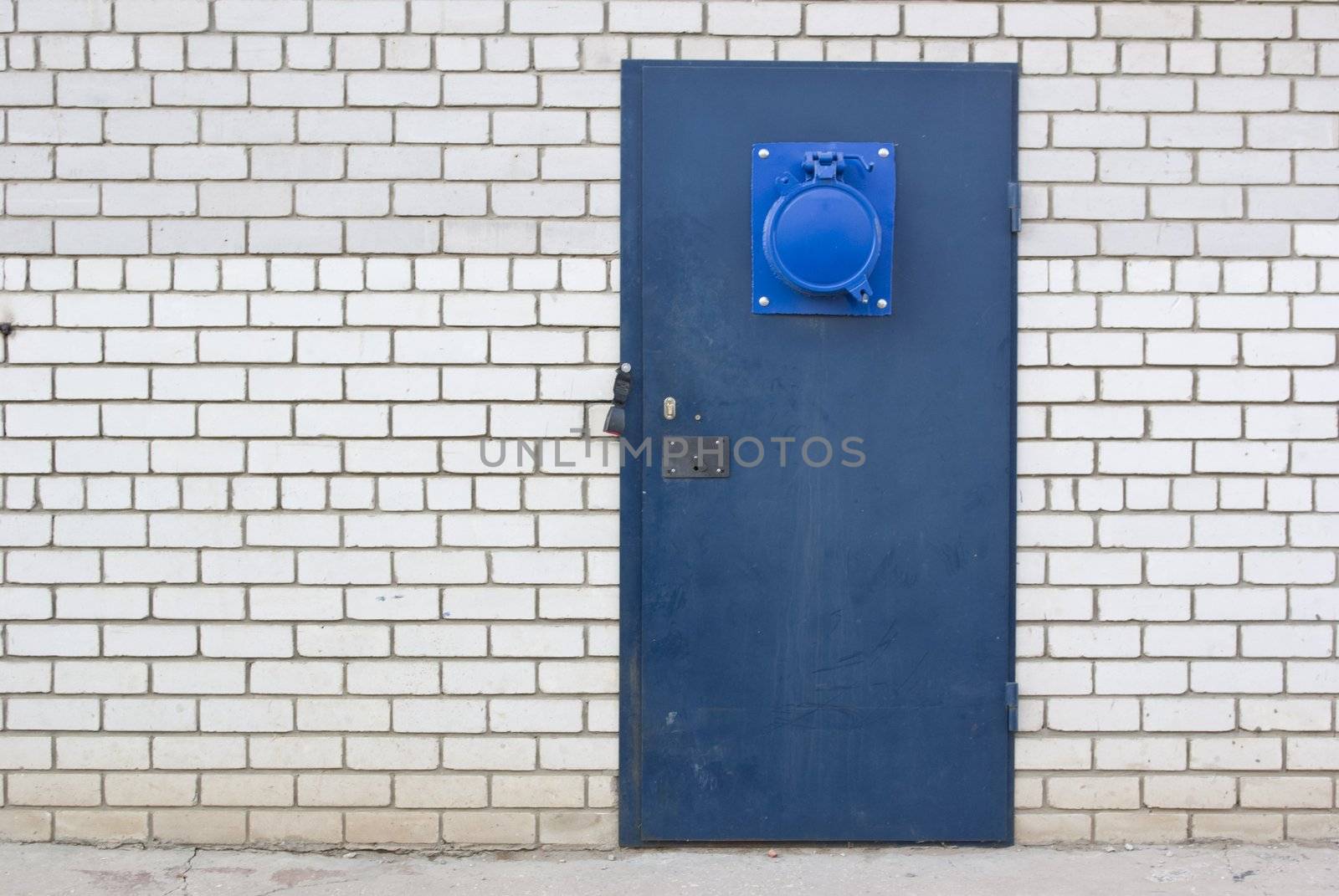 the blue steel door in the brick white