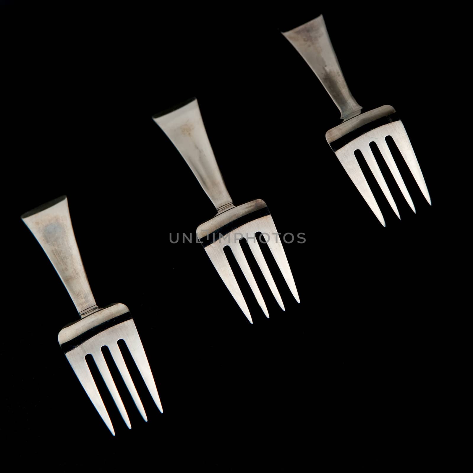 Five forks against black background. Cover set