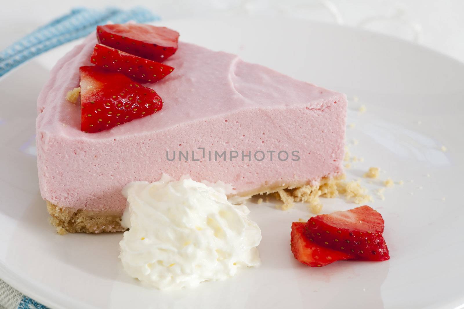 Strawberry mousse with gram cracker crust, whipped cream and fresh strawberries