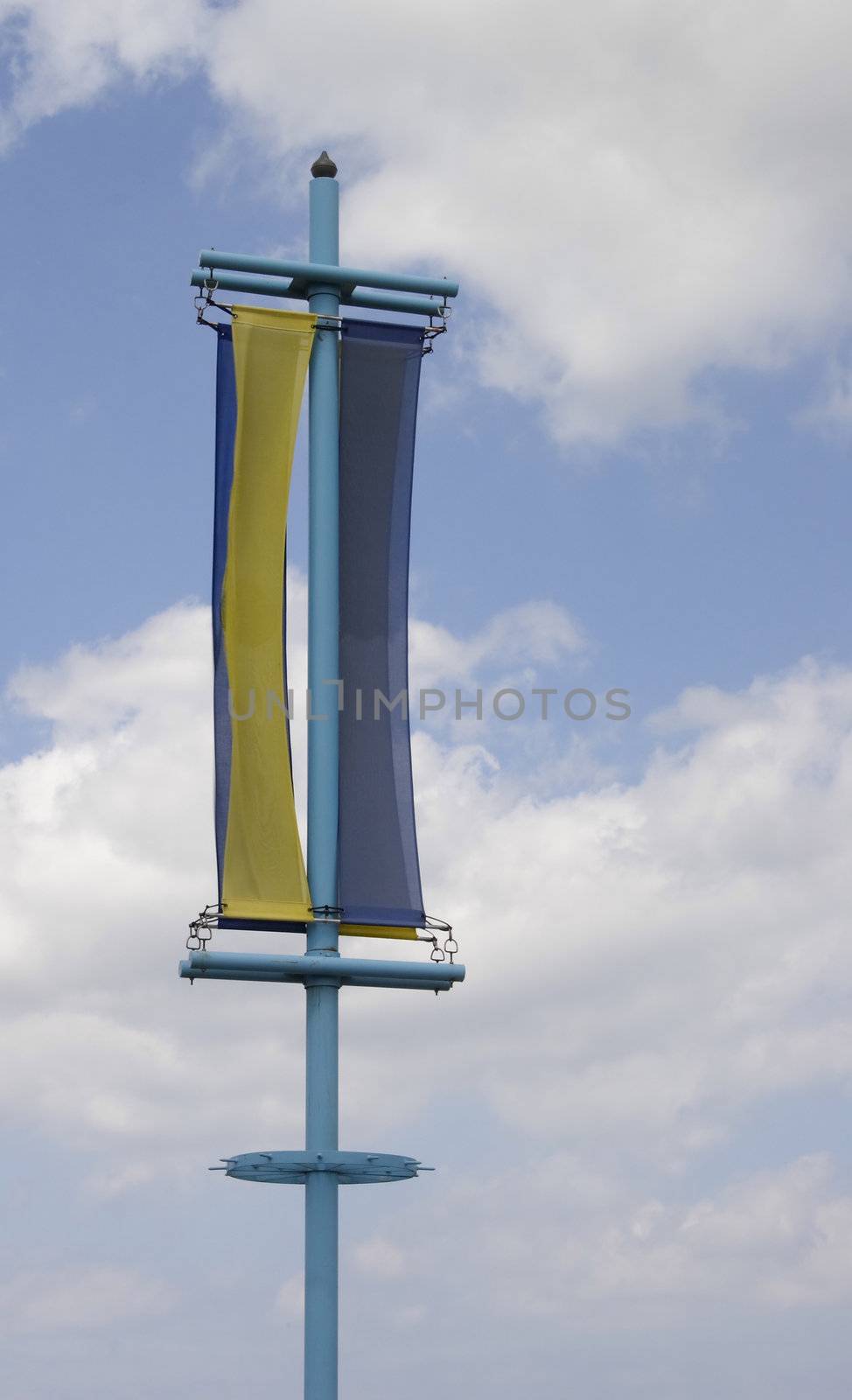 yellow and blue banner against a sky background