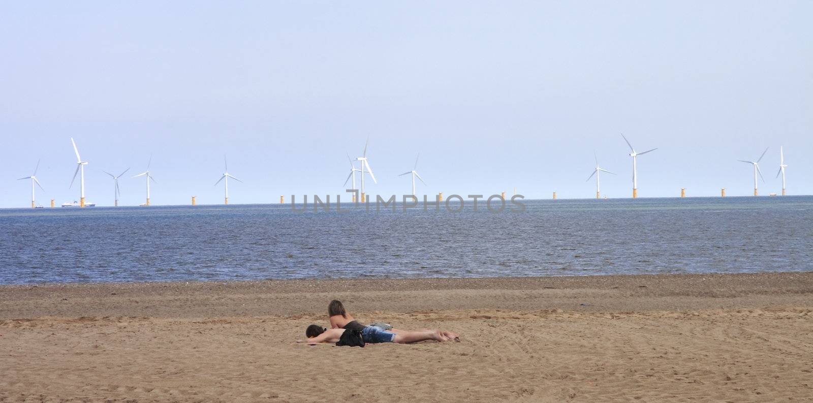 couple on the beach by leafy