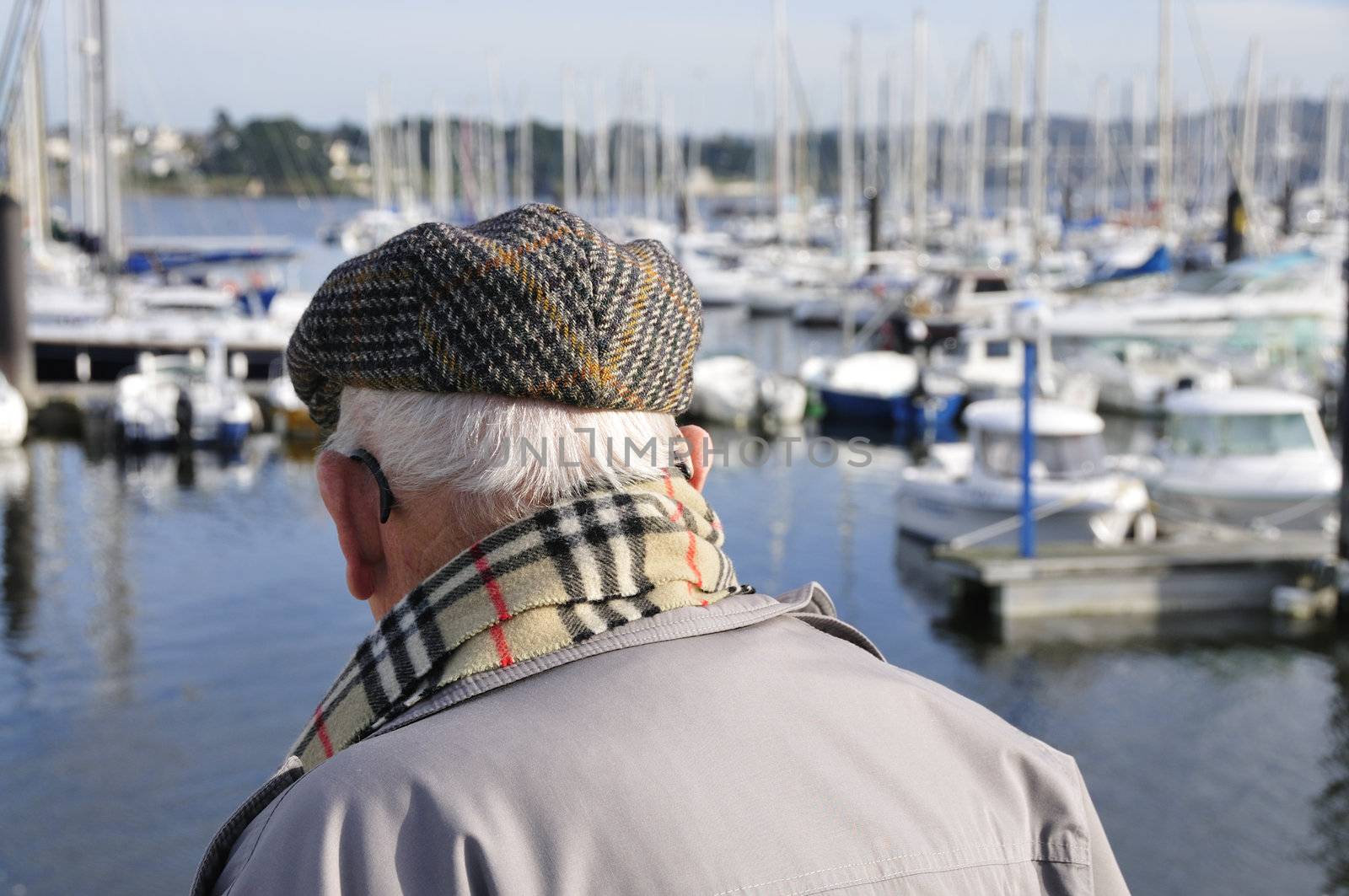 Old french senior man watching yachts at the harbor of Brest in France, Brittany