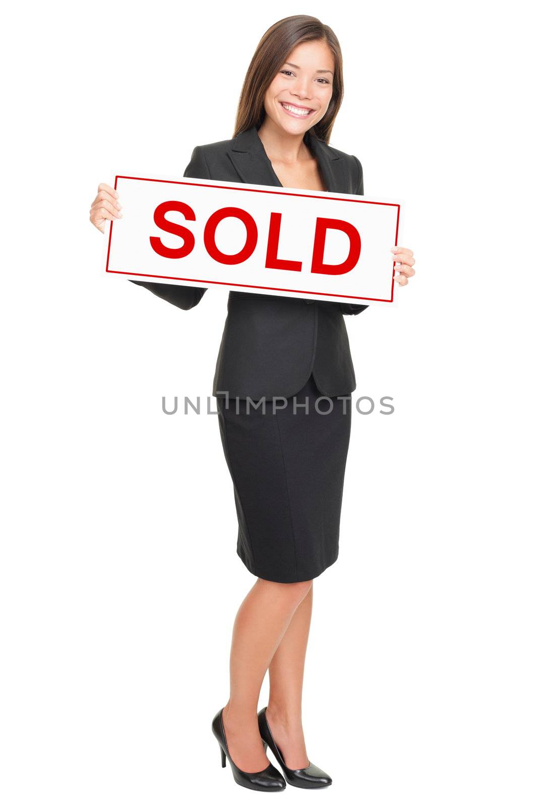 Real estate agent showing sold sign isolated on white background. Beautiful smiling Asian / Caucasian female realtor standing confident in full length.