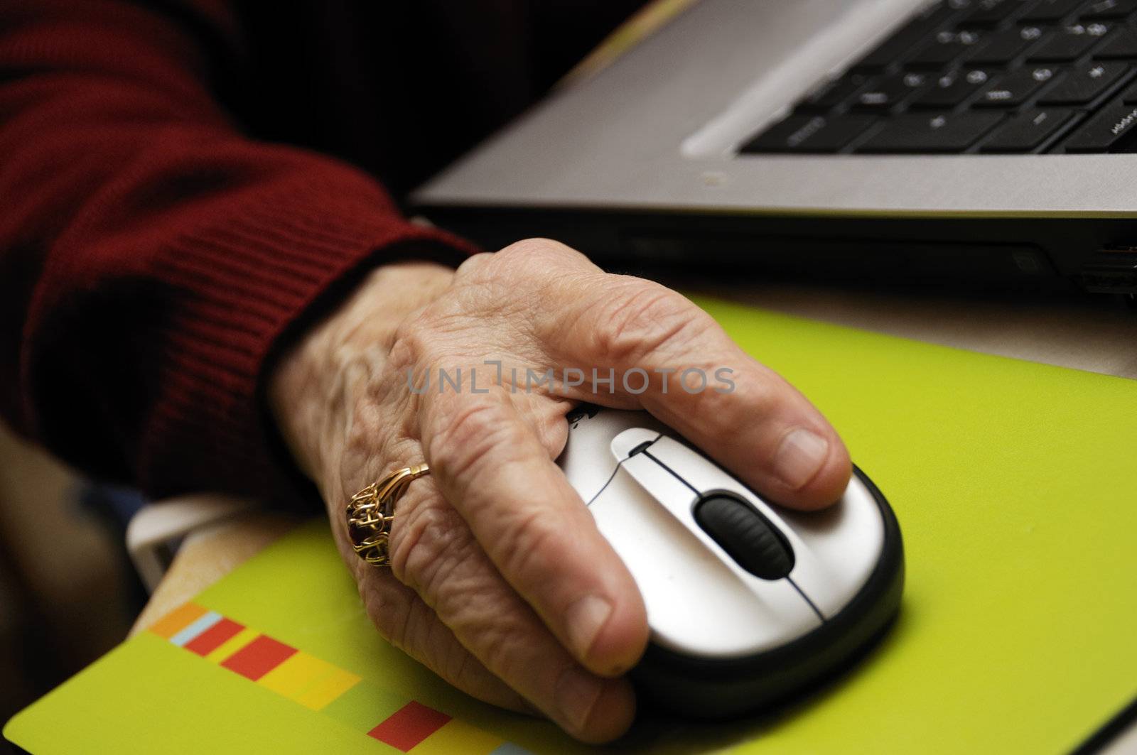 Shot of hand of senior woman surfing the web