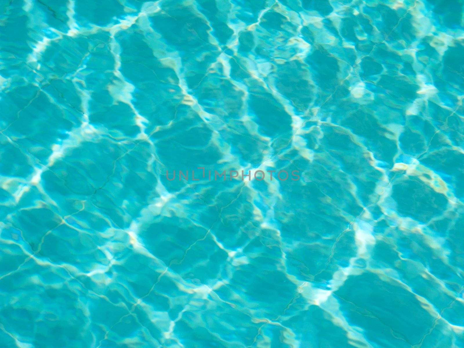 Blue pool water with sun reflections