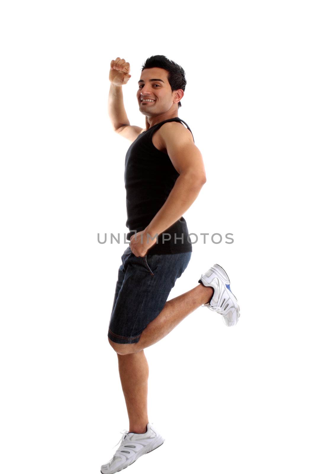 An energetic happy man jumping or leaping into the air and smiling.  Motion in forearm.  White background.