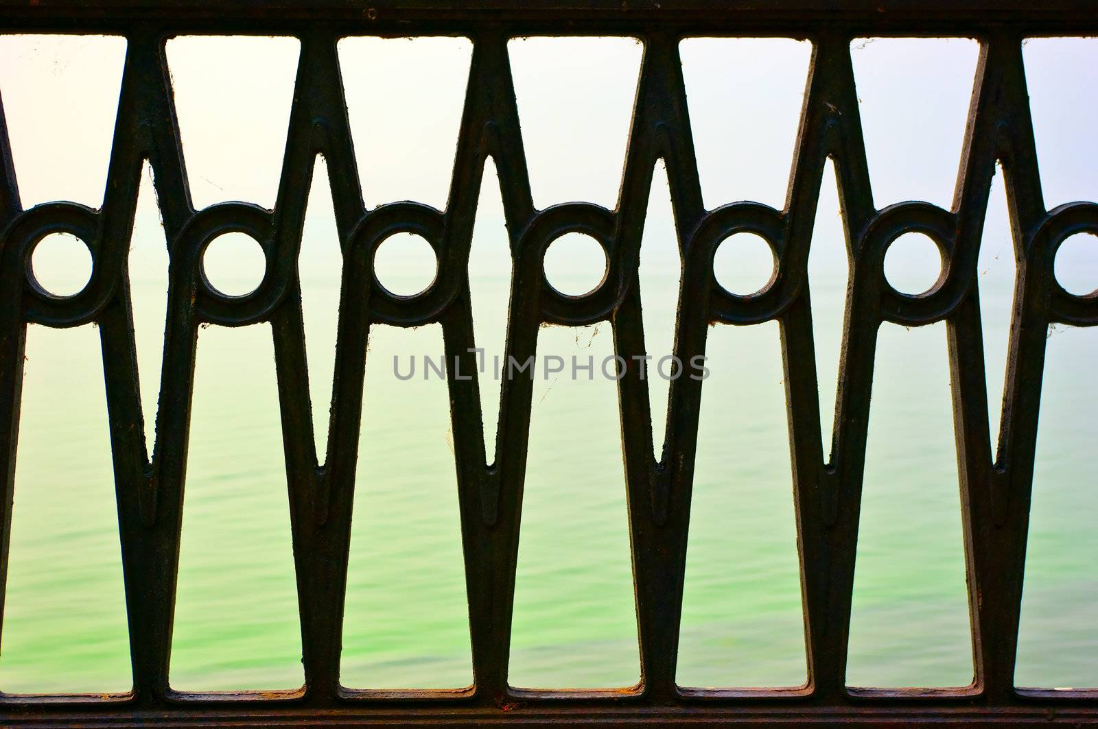 the beautiful forged fence against the sea