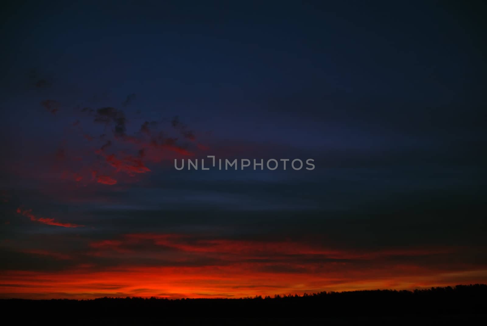 the dark red sunrise background with clouds