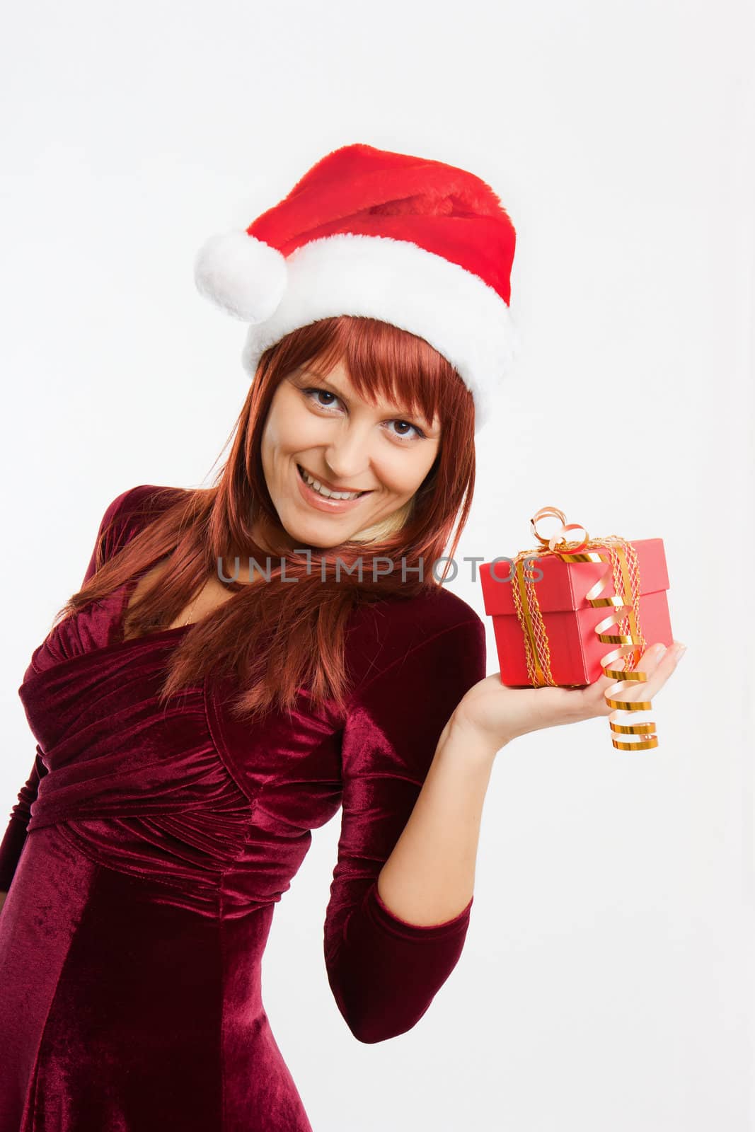 admiring a girl in a Christmas hat holding a New Year gift
