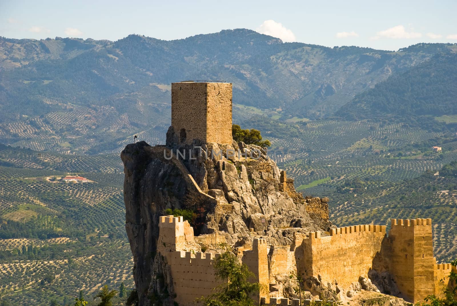 The castle of Cazorla in Andalusia, Spain against a landscape of olive trees