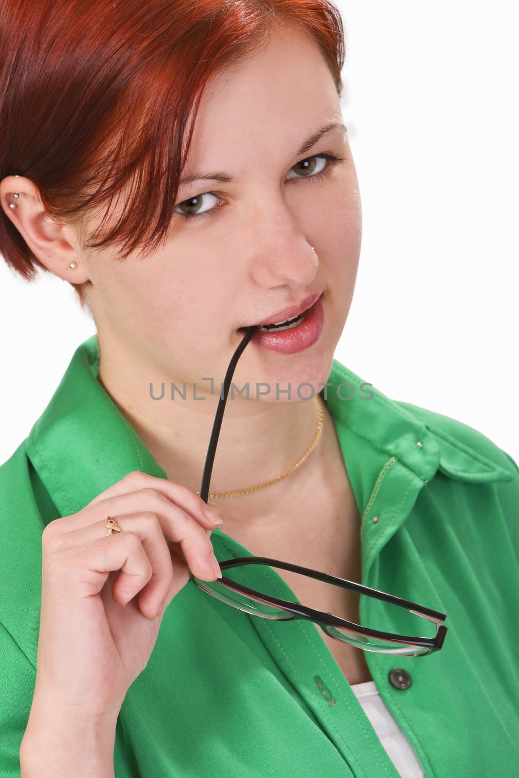 Portrait of a young redheaded girl looking slick with the sidepiece of her glasses in her mouth.