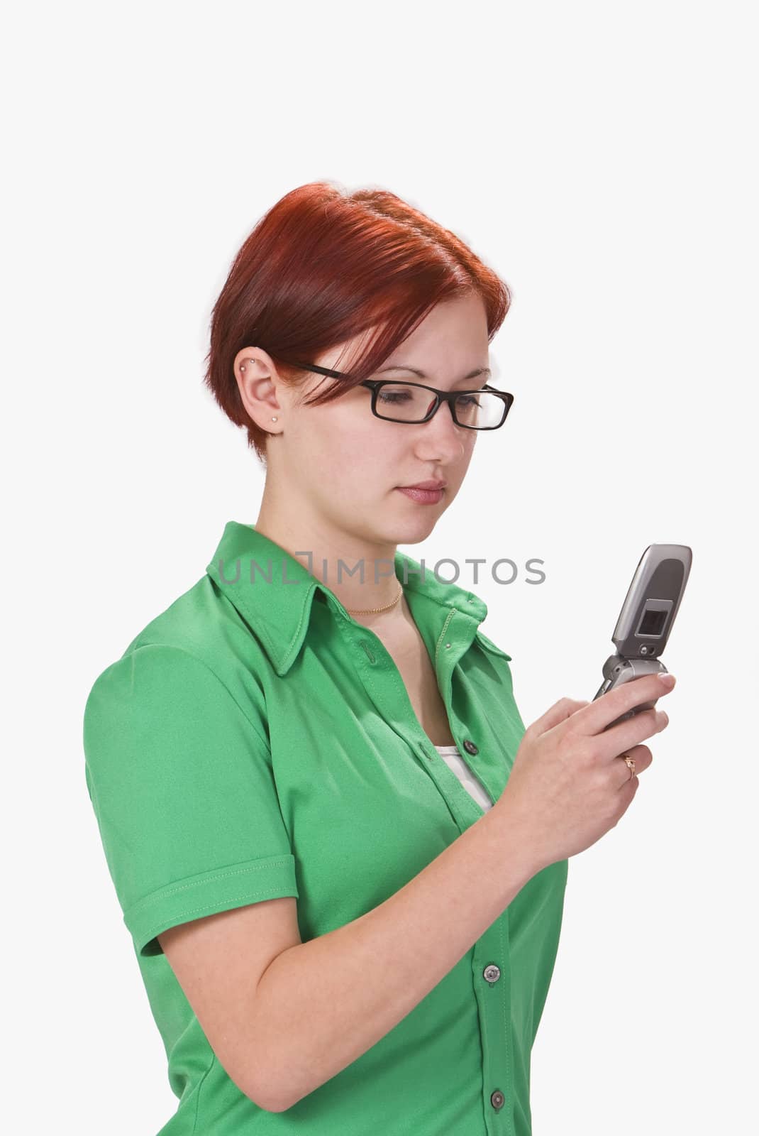 Image of a redhaeded girl checking her mobile phone for a text message.Shot with Canon 70-200mm f/2.8L IS USM