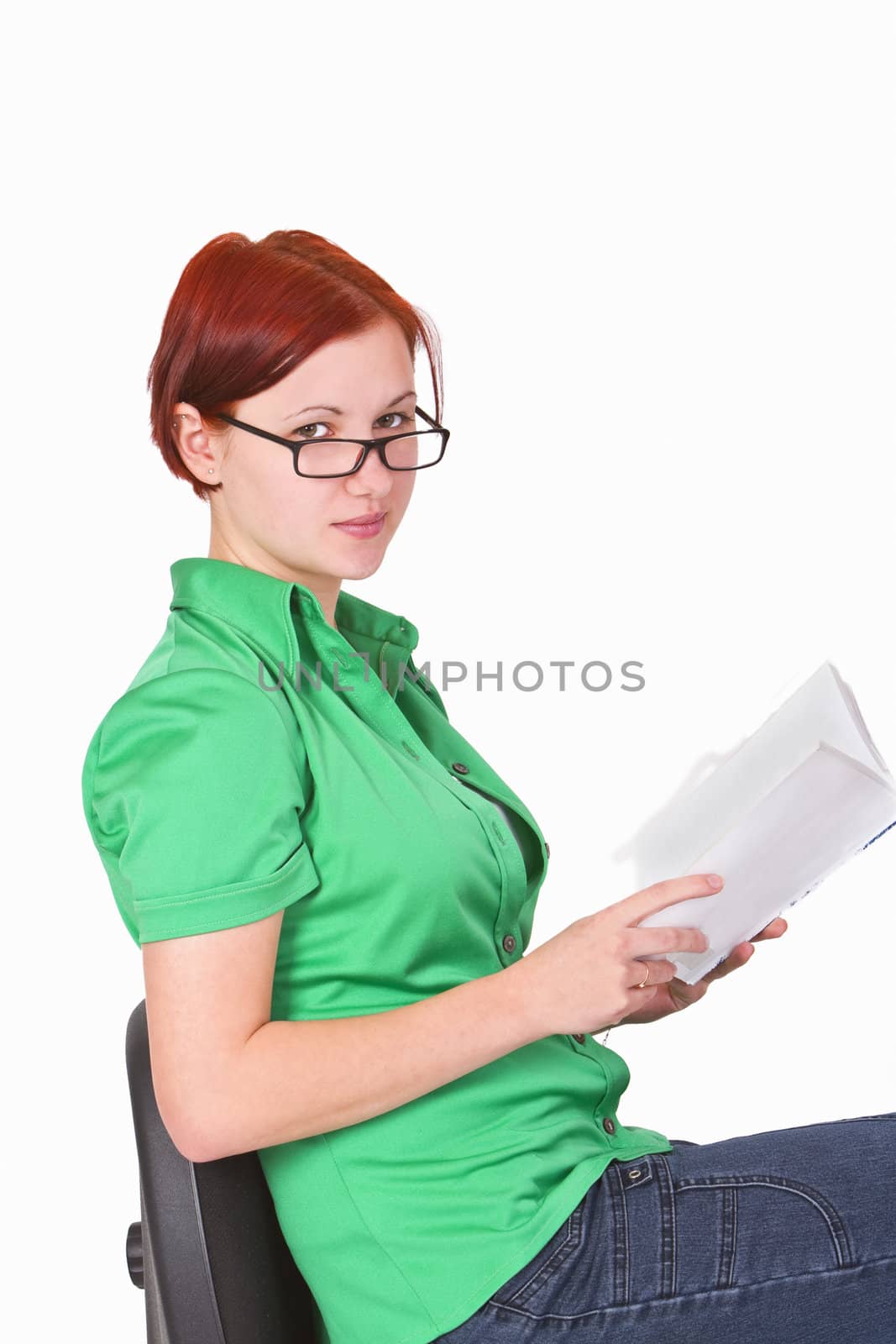 Close-up image of a young redheaded teenager with a book in her hands.