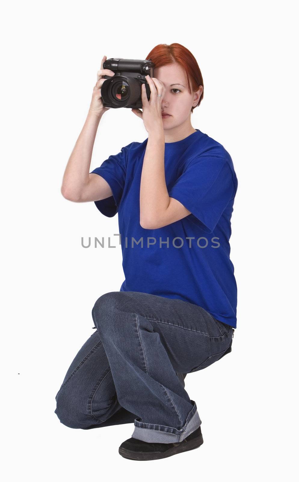 Redheaded girl taking photos with a DSRL camera. 