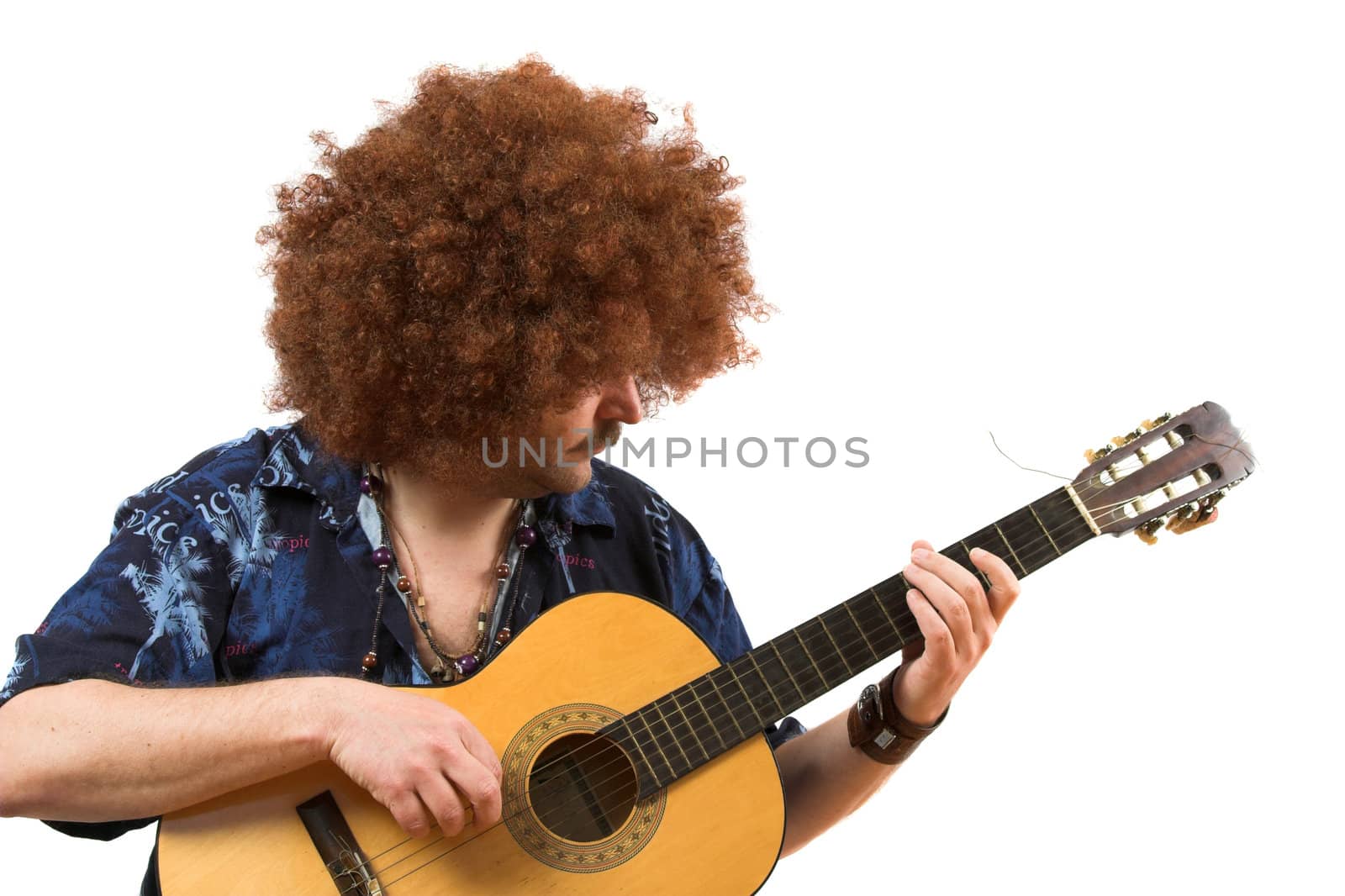 Old hippie with wild afro hair playing his guitar (text on shirt is not a brandname)