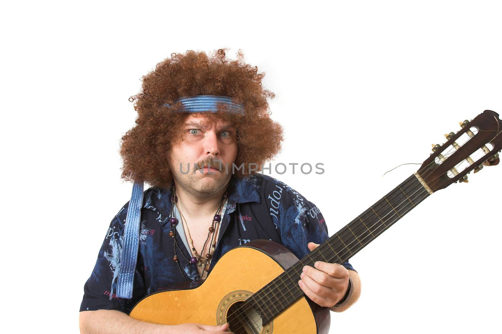 Old hippie putting on a face while playing his guitar