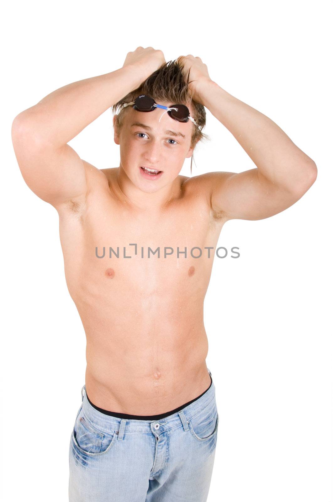 Young wet swimmer boy in blue jeans