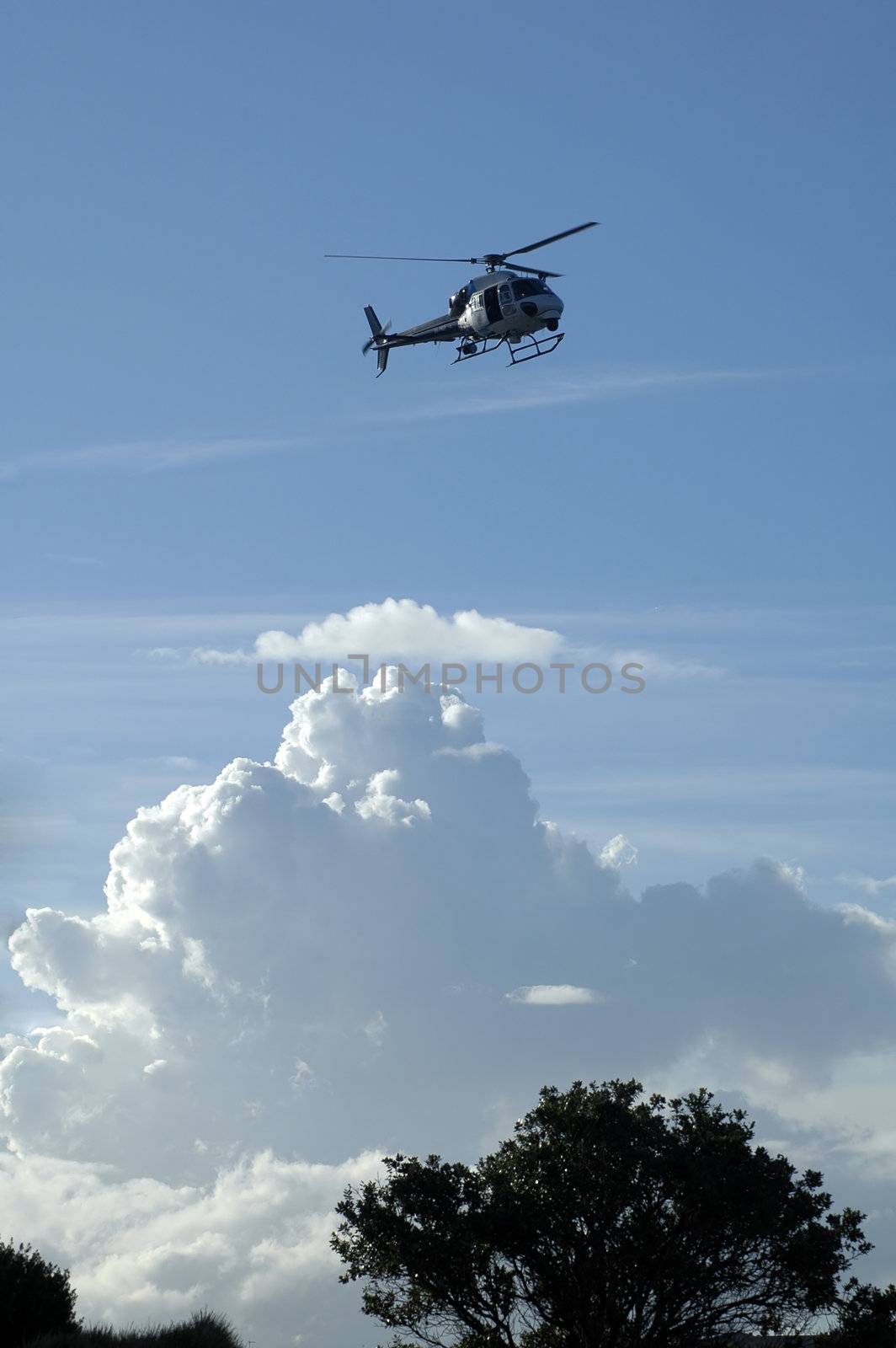 police helicopter above ground, clouds in background, photo taken in Sydney