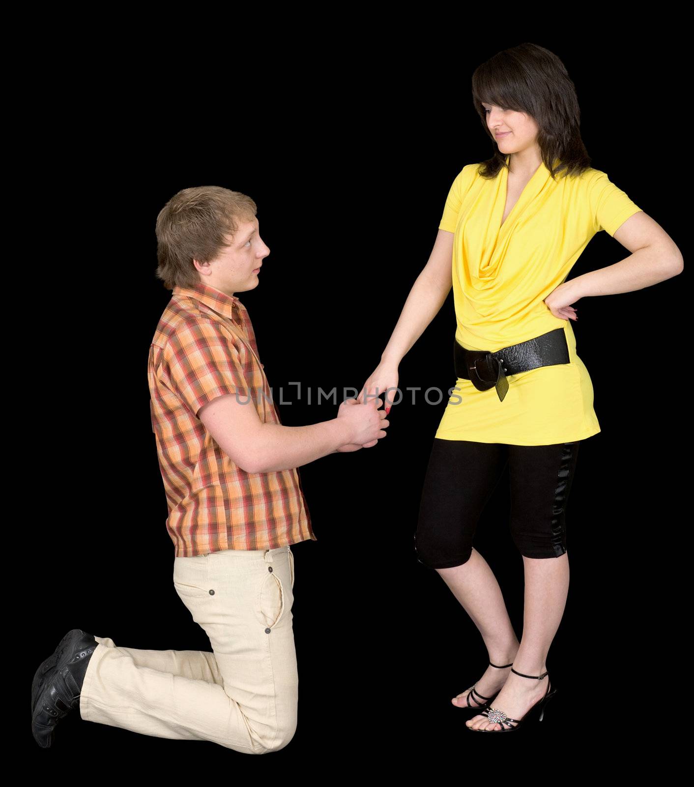 The man is kneeling to the young woman