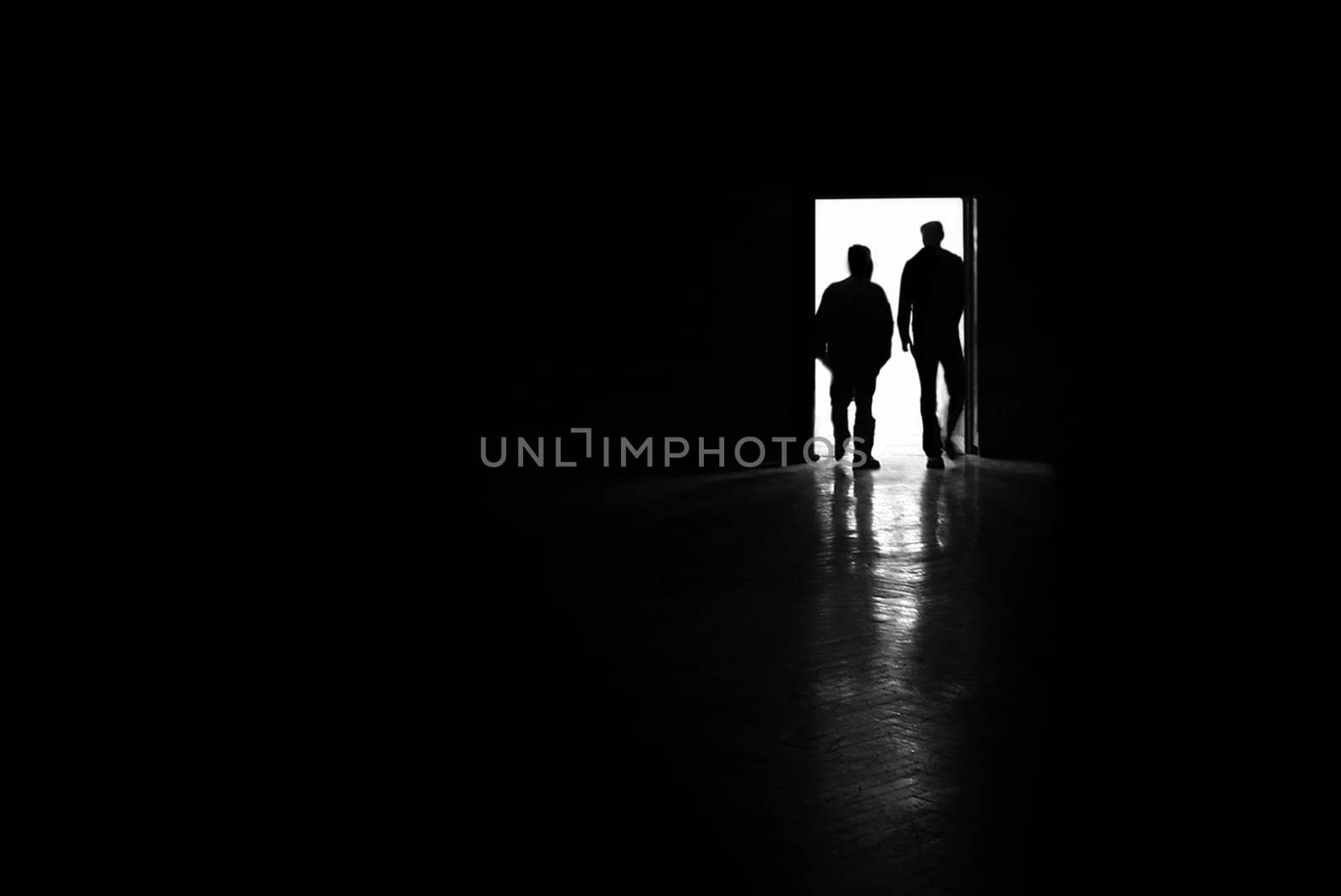 two man silhouettes entering a room, black and white photo