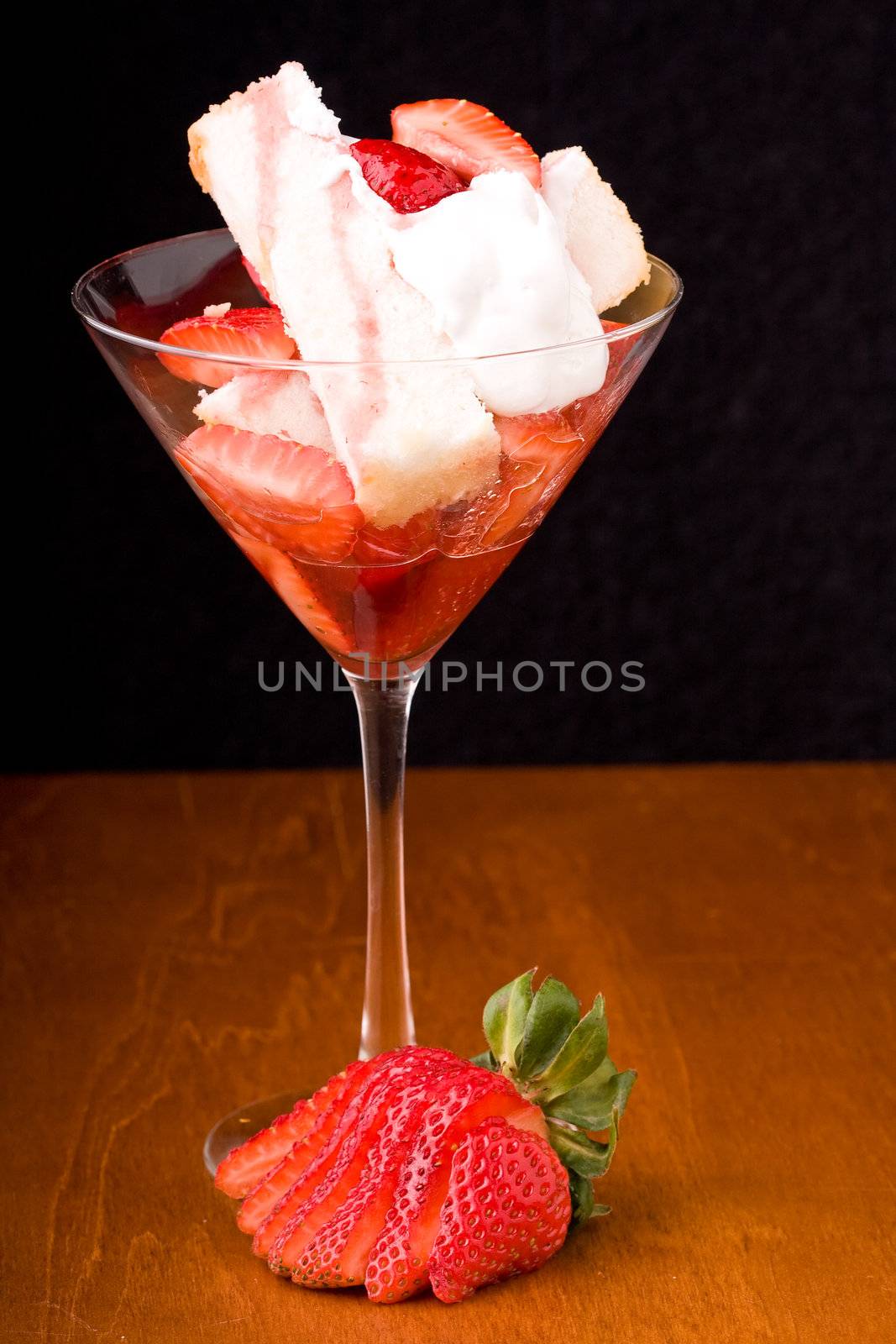 Strawberry shortcake in a martini glass sponge cake and whip cream