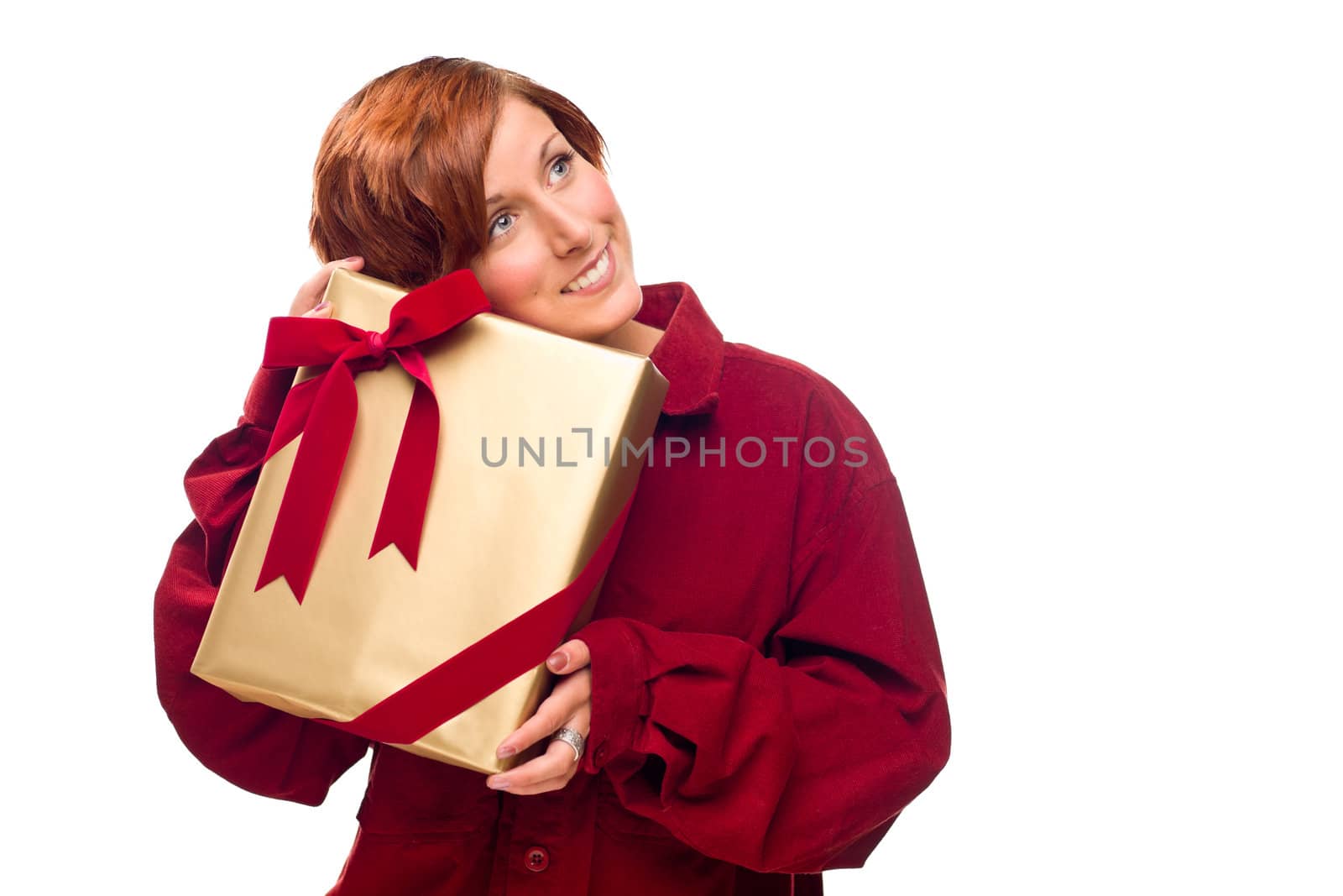 Pretty Red Haired Girl Rests Her Head on a Precious Wrapped Gift Isolated on a White Background.