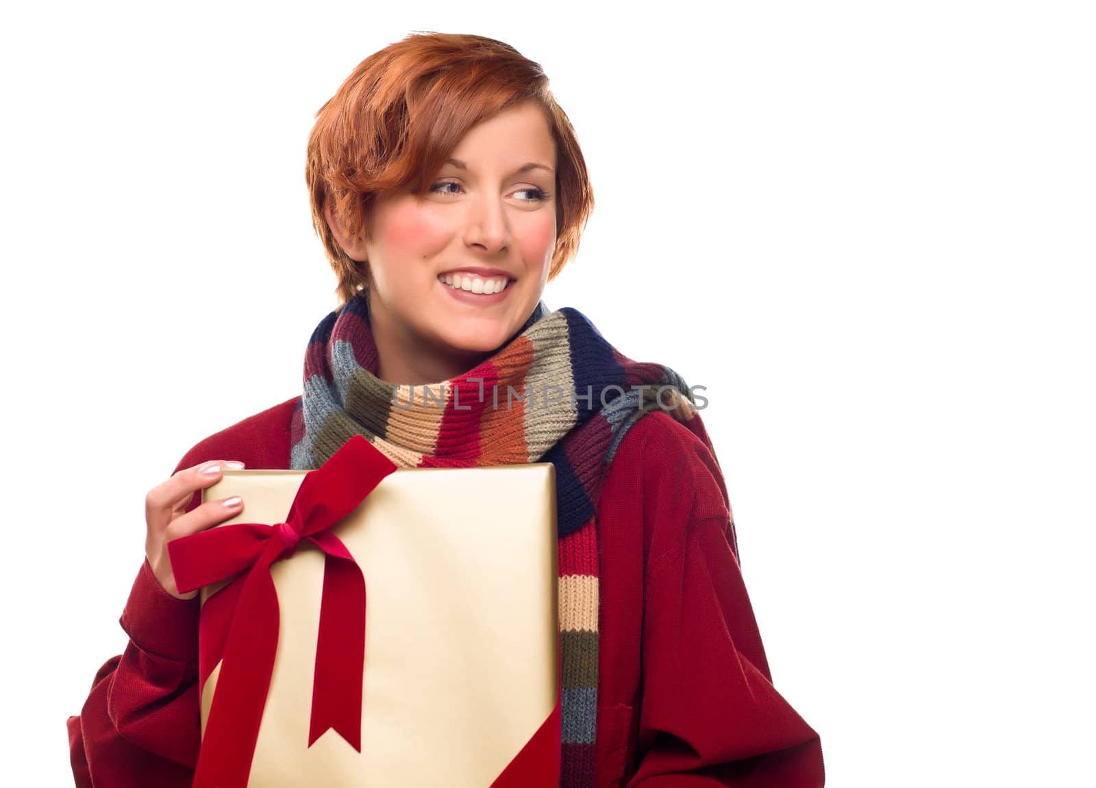 Pretty Red Haired Girl with Scarf Holding Wrapped Gift Looking Off to the Side Isolated on a White Background.