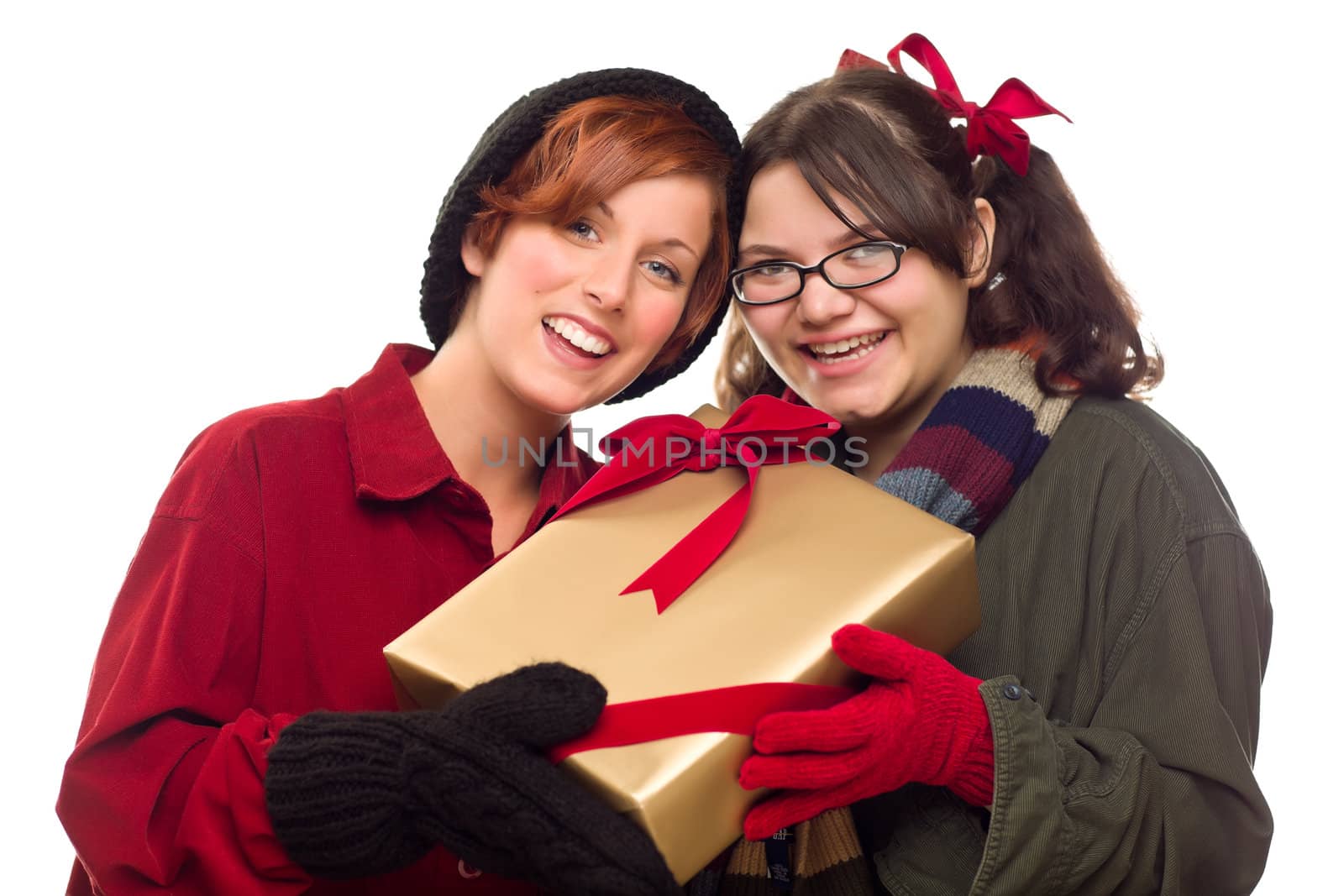 Two Pretty Girlfriends Holding A Holiday Gift Isolated on a White Background.