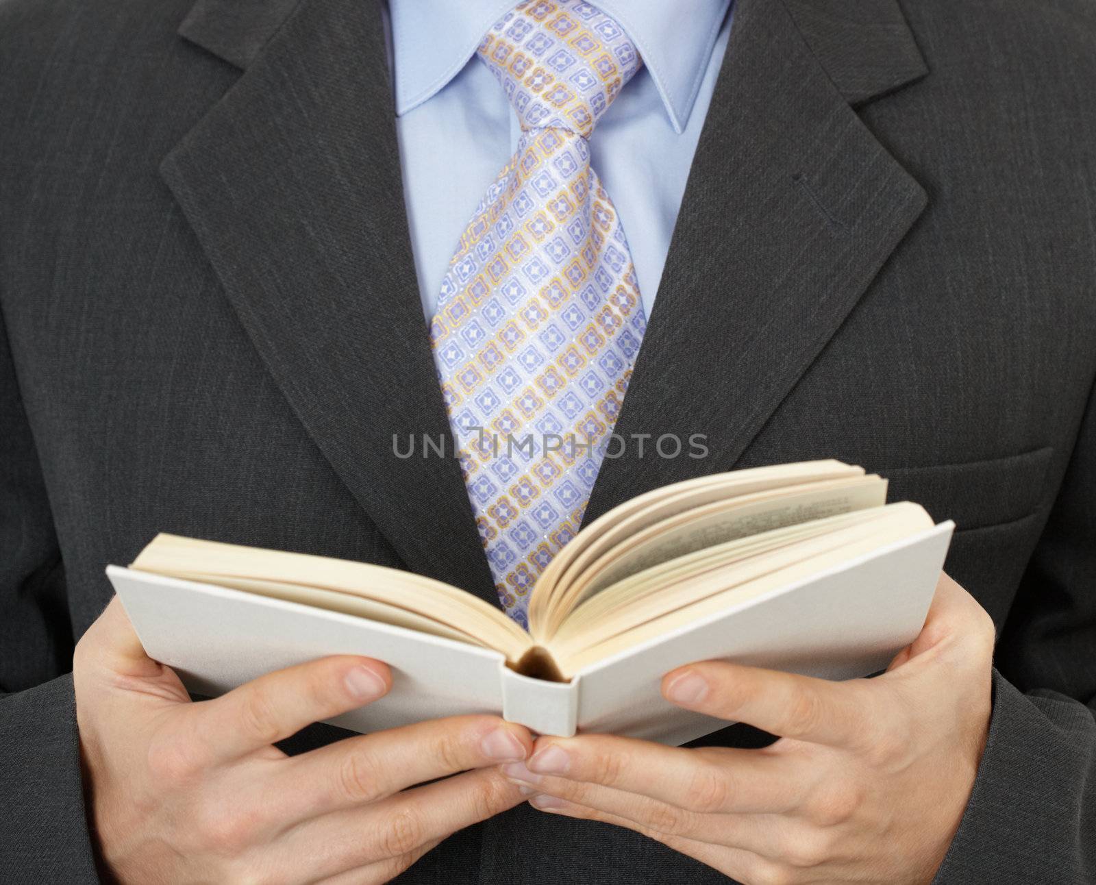 Business man reading a statute book - close-up