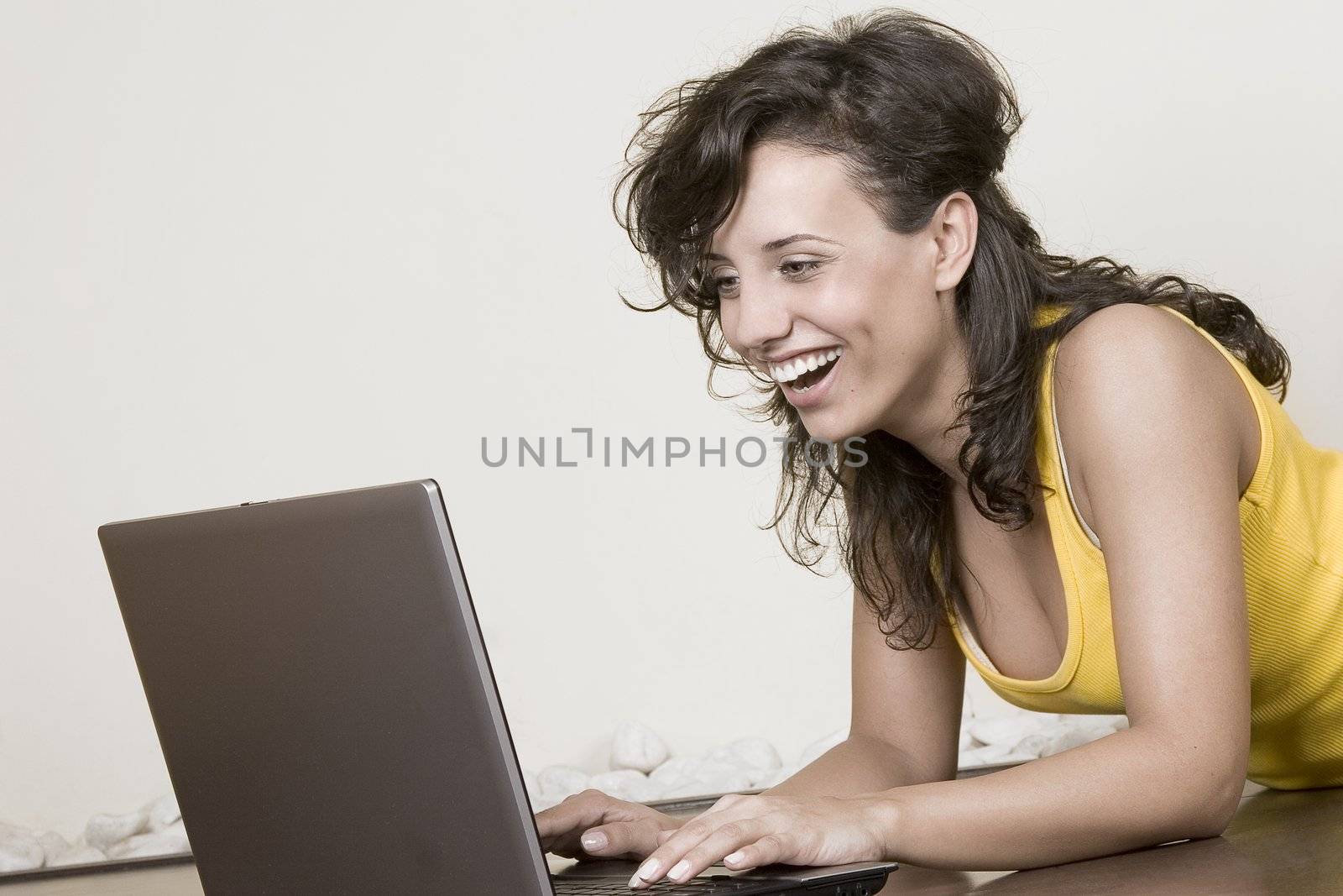 laughing girl with the laptop lying on the floor by VictorO