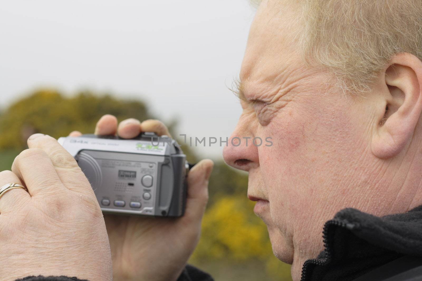 man with a digital camcorder by leafy