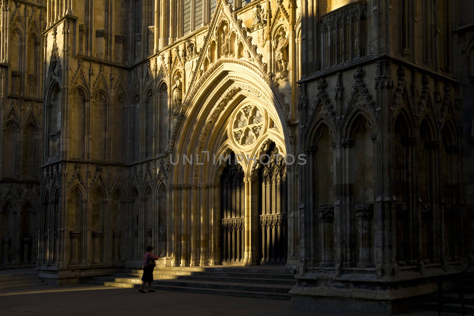 A lady standing humbly before the architecturally magnificent York Minster