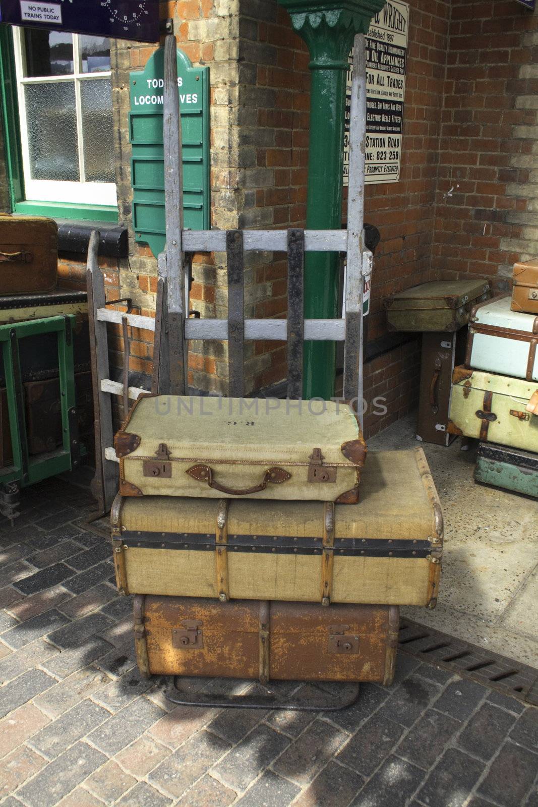 old trunks and cases on a sack truck at a  railway station