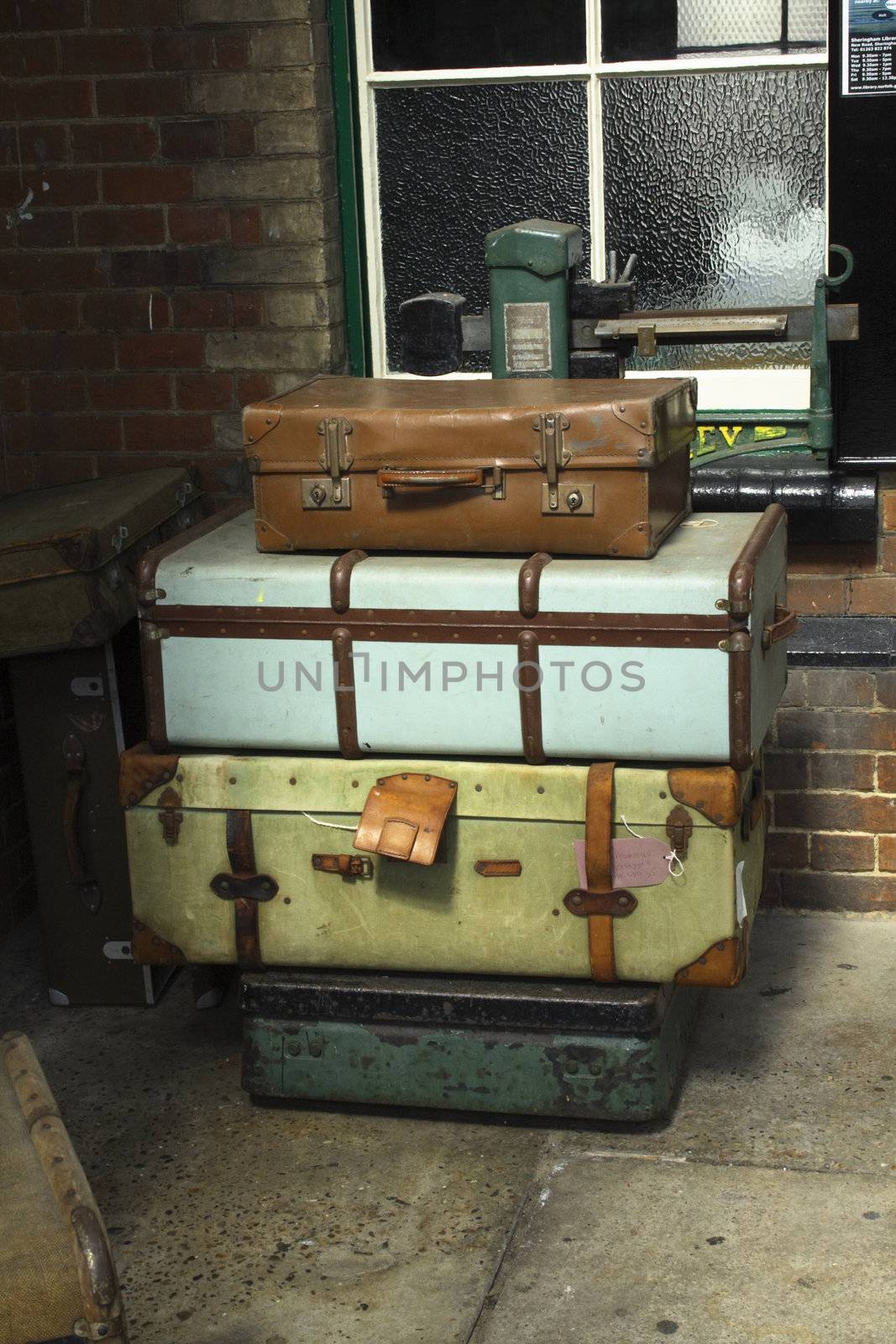 cases and old trunks on scales at a railway station