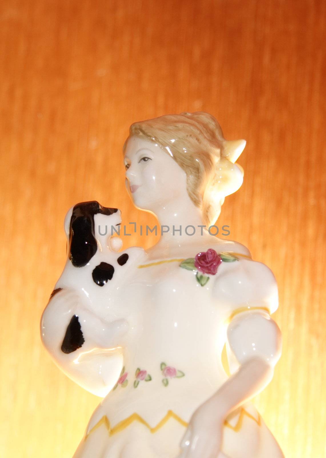 figurine lit frome behind against a wooden background