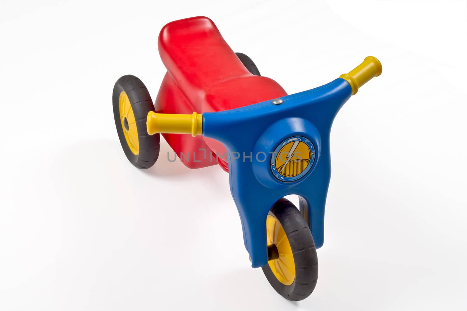 Red,blue,yellow toy motorcycle isolated on white