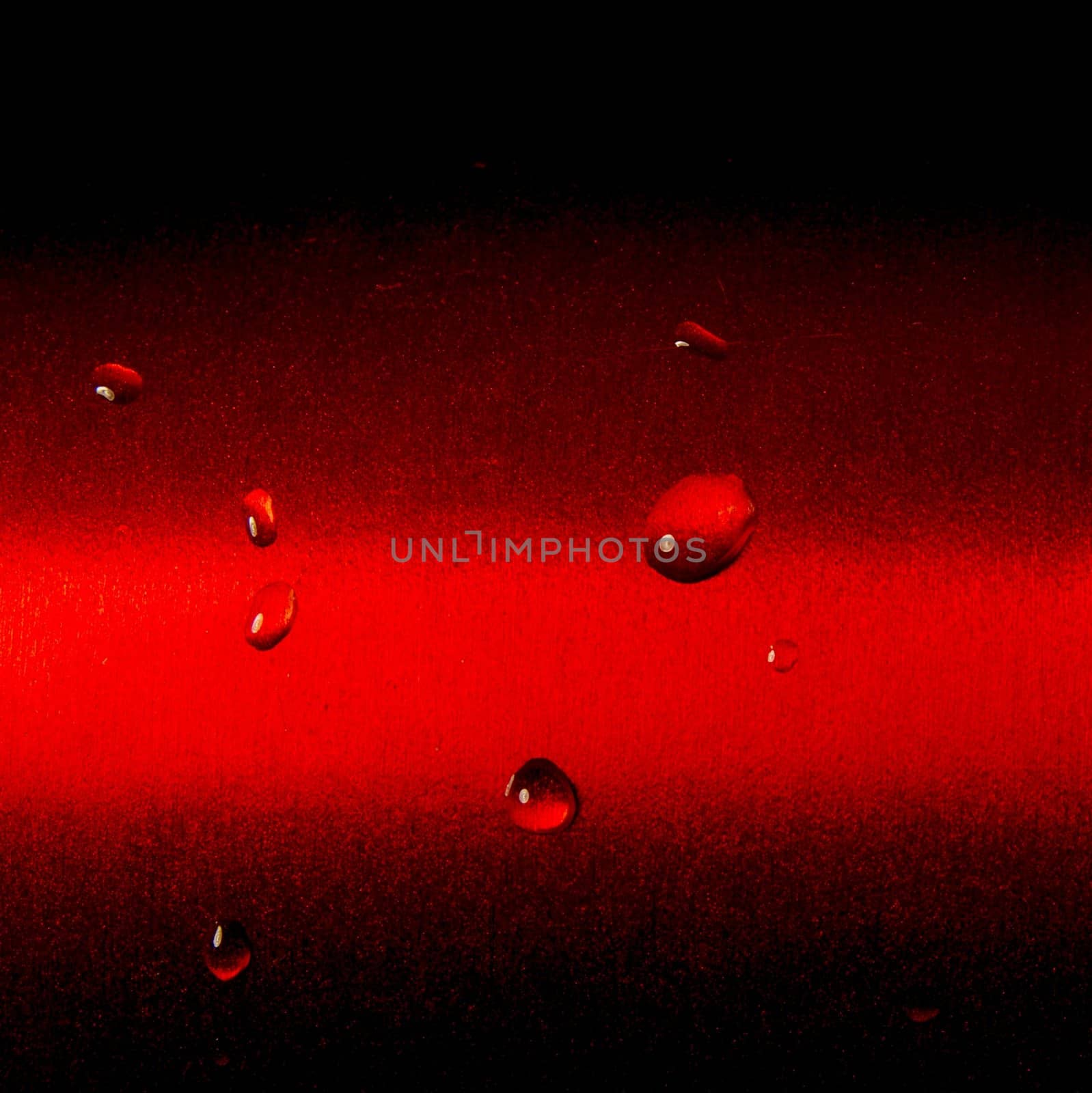 Some raindrops on red metallic surface