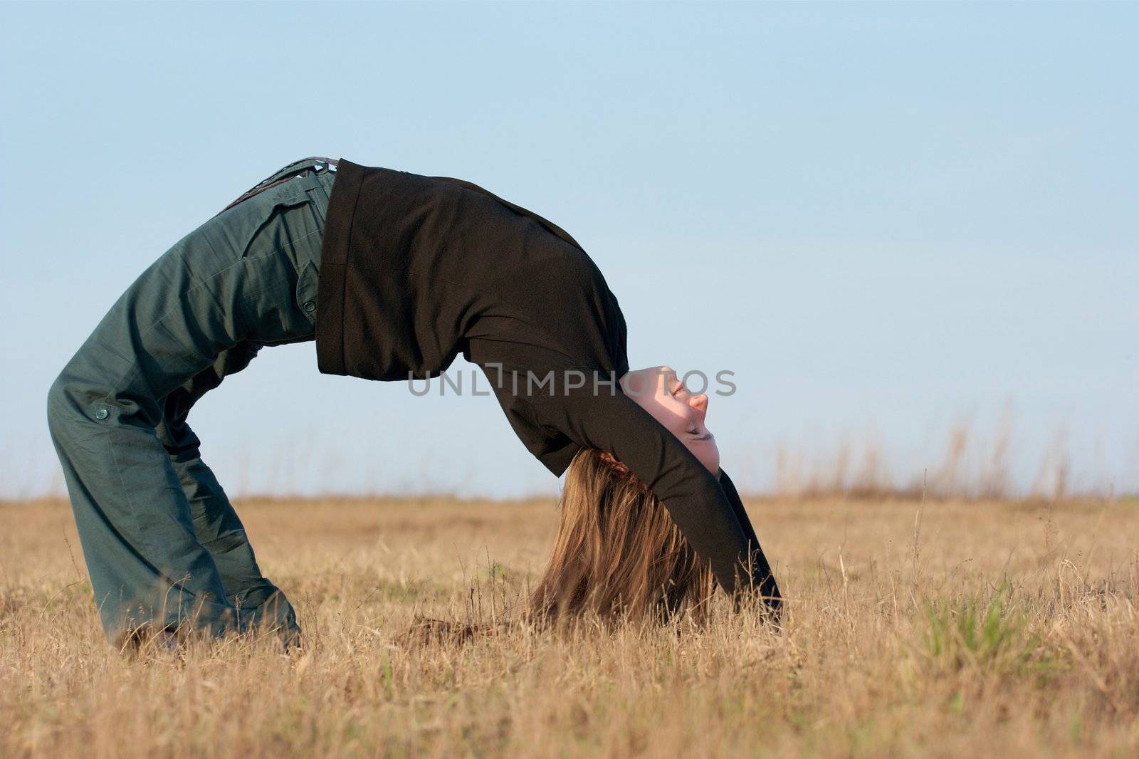Girl bending over on a field