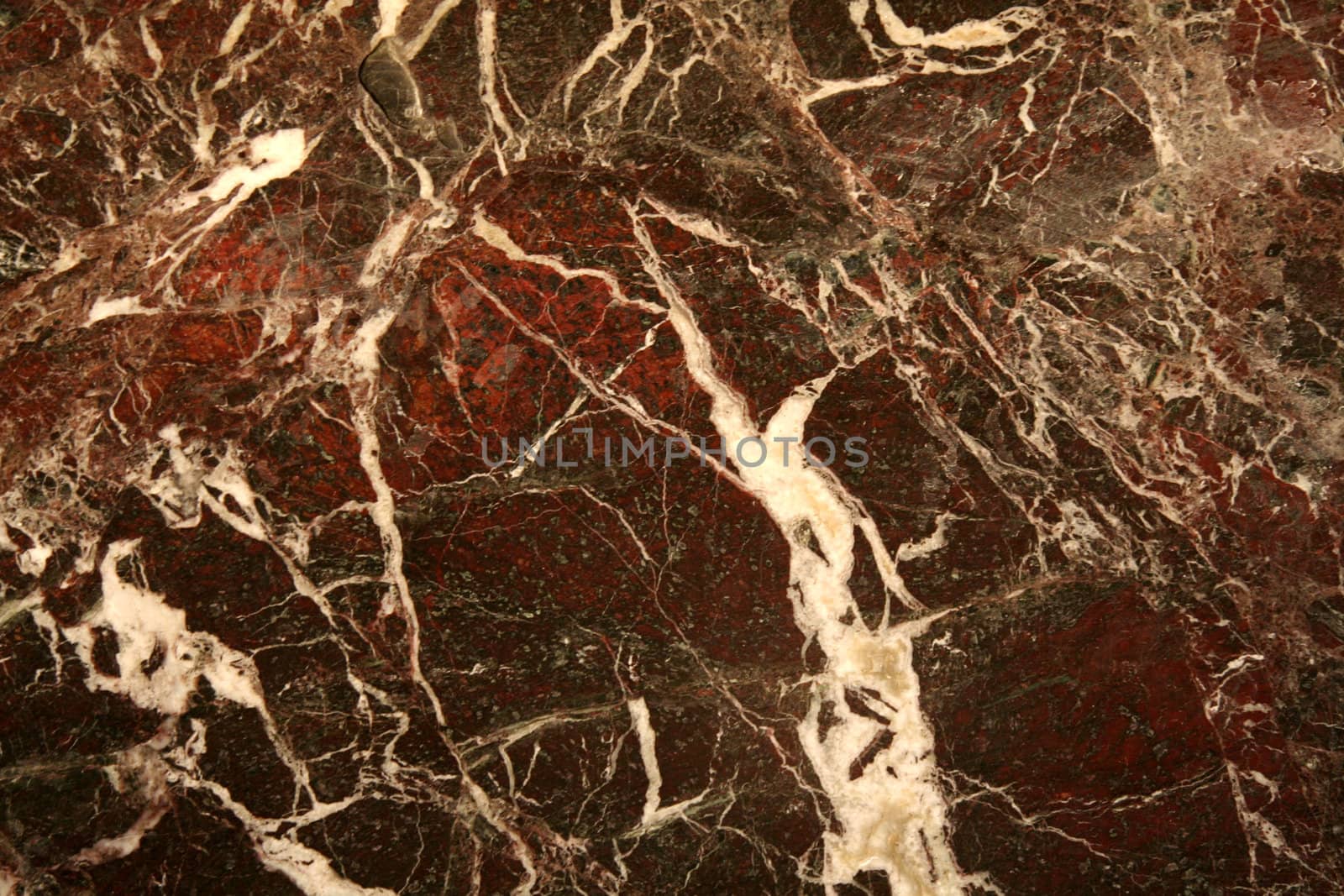 A red marble texture with white lines running through it.