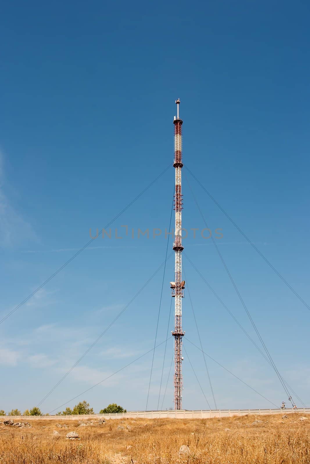 Tall communication tower on a barren land