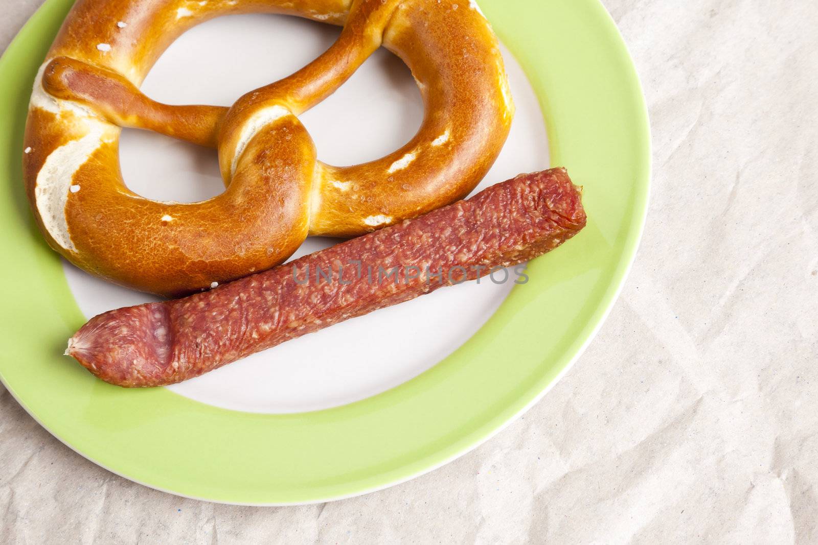 An image of a typical german sausage with a pretzel