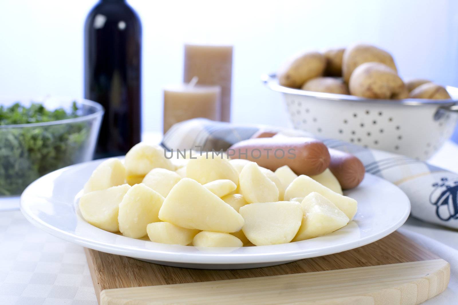 Peeled and cut potatoes, sausage and kale, ingredients for a Dutch stamppot.