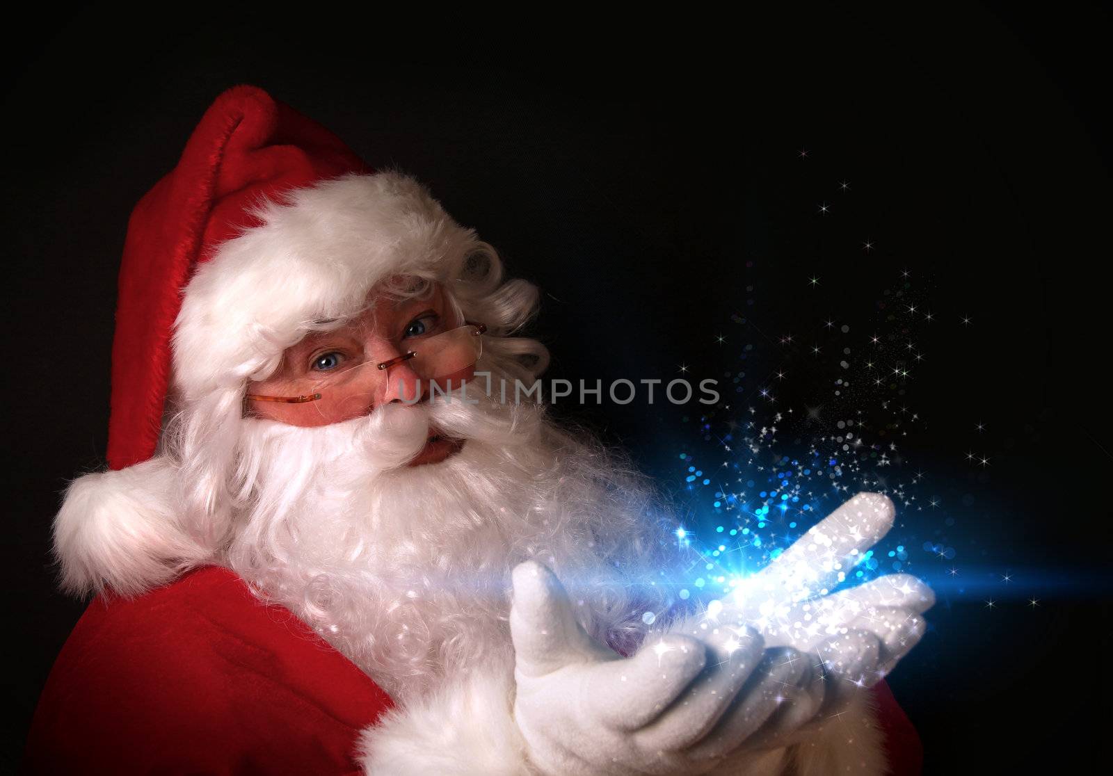 Christmas theme with Santa holding magical lights in hands