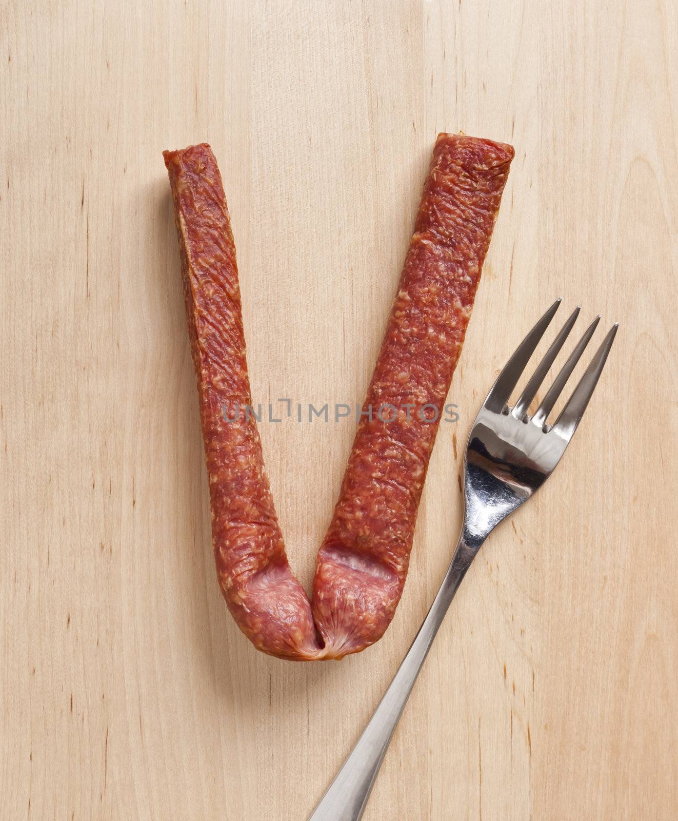An image of a german sausage and a fork