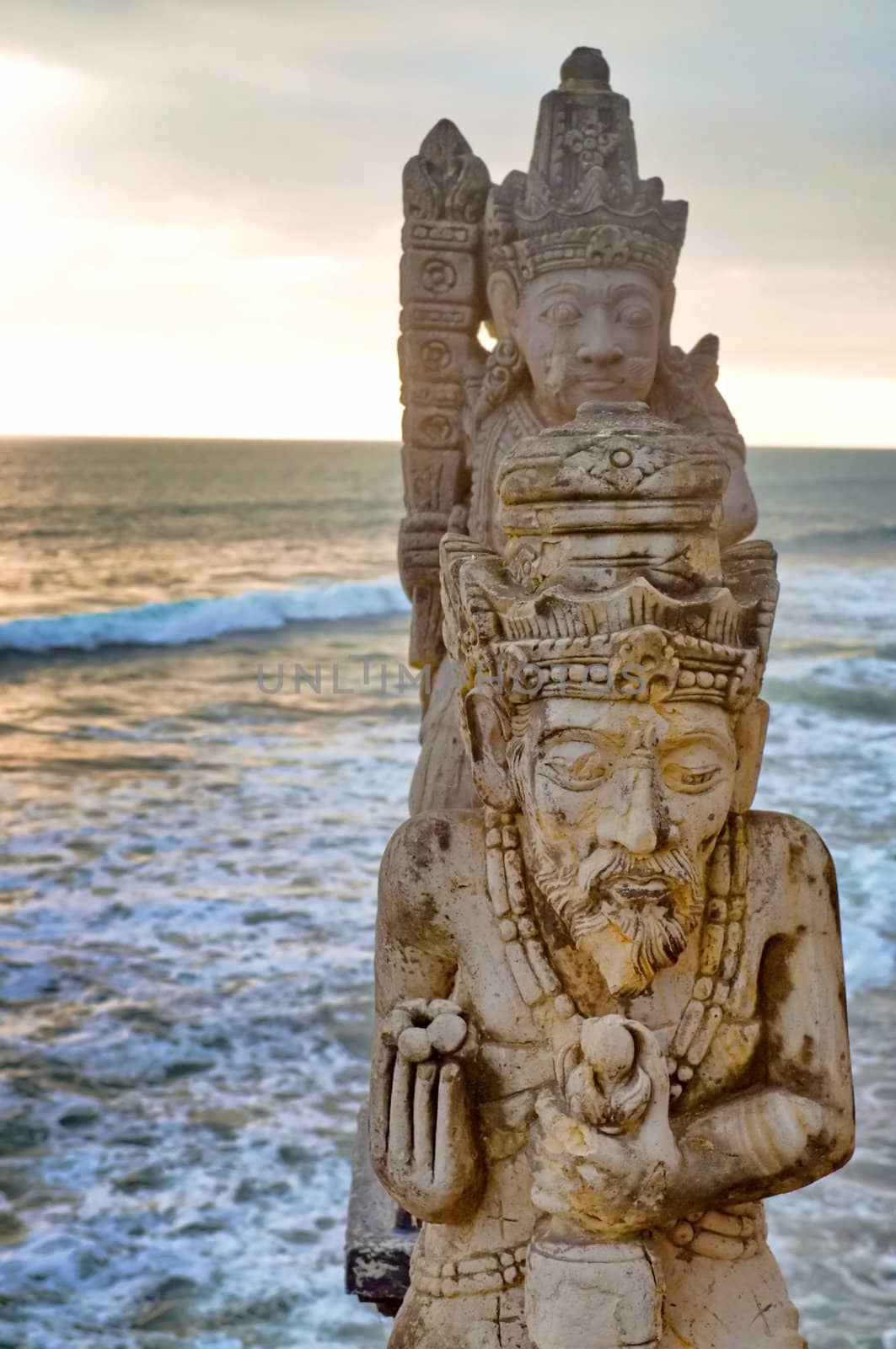 Balinese statue sculpture in front of a ocean background