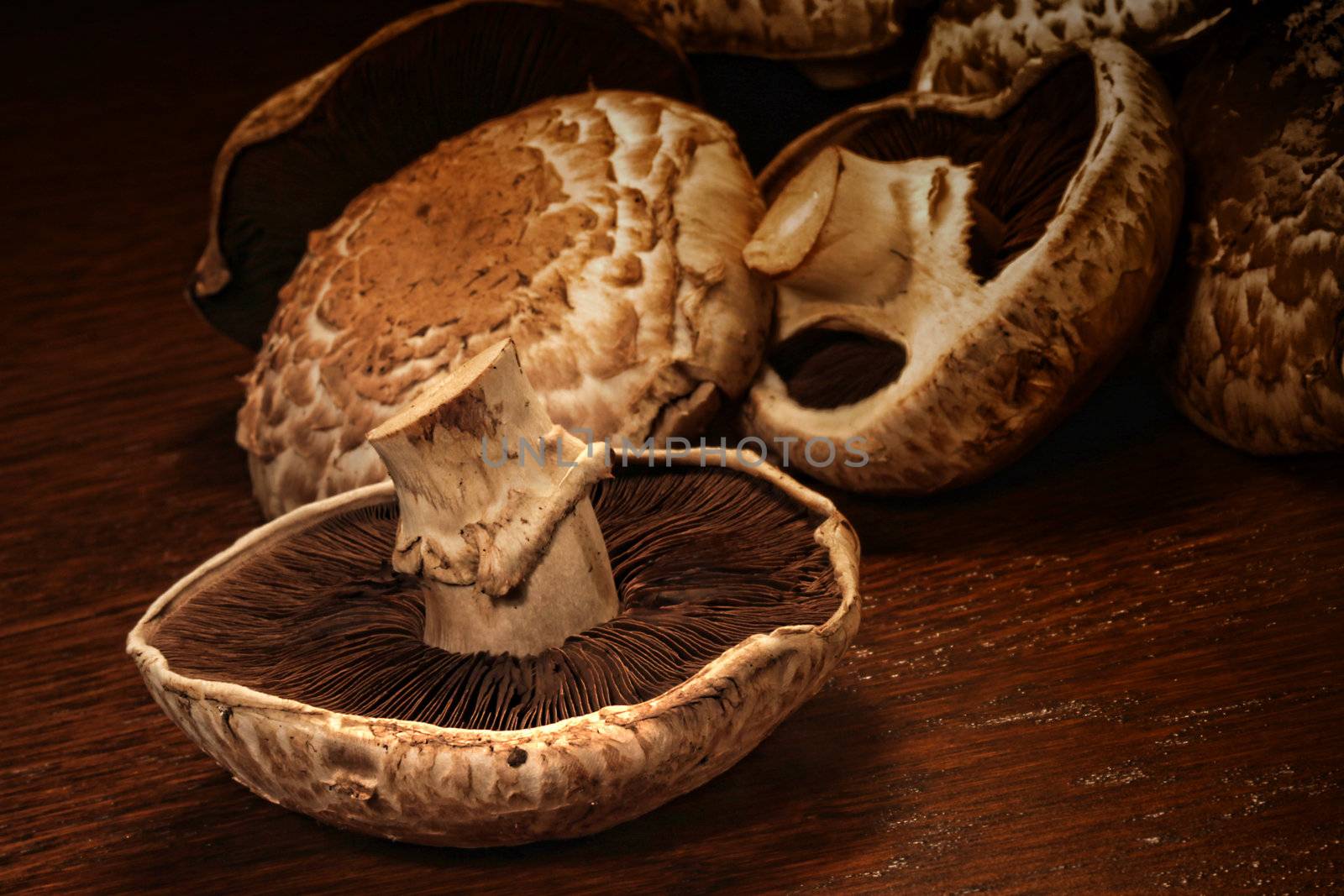 Fresh portobello mushrooms on wooden surface 