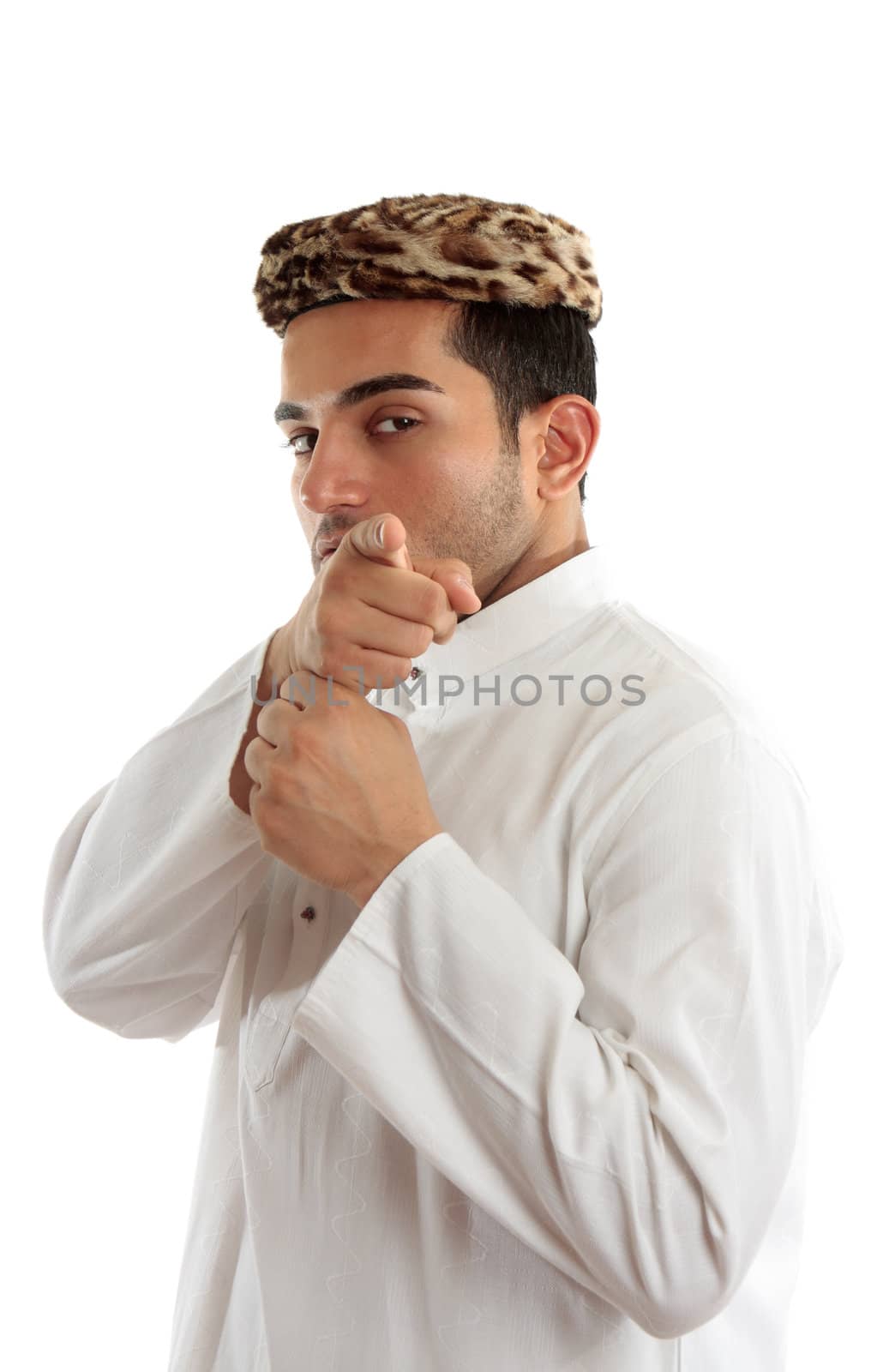 Ethnic man pointing his finger at you or something else.  He is dressed in cultural clothing.  White background.